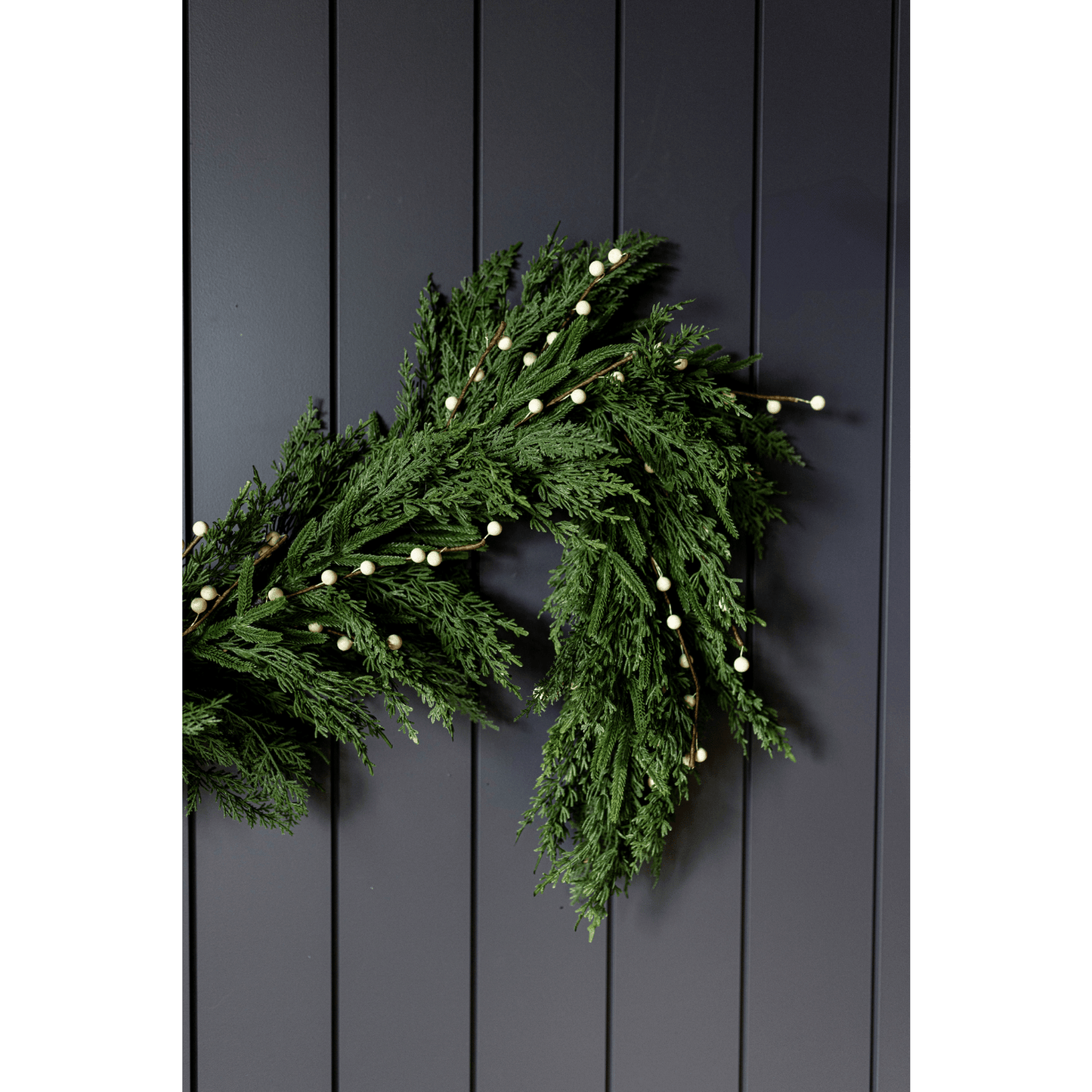 6 ft White Plum Berry Norfolk Cypress garland with real touch evergreen and white berries on dark background