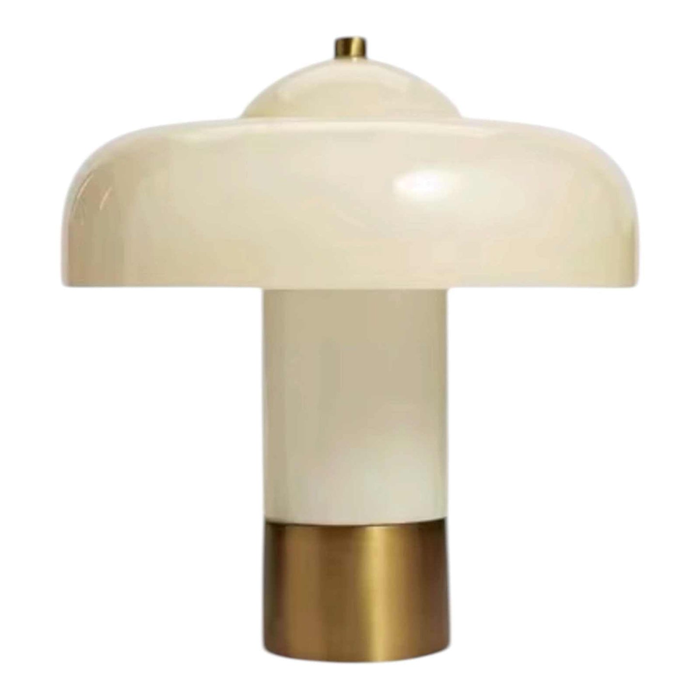 Ivory mushroom lamp with glossy glass shade and brass base emitting warm ambient light