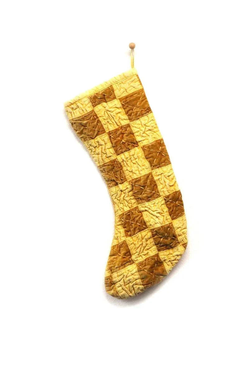 Yellow checkered Christmas stocking with golden tones and checkmate pattern