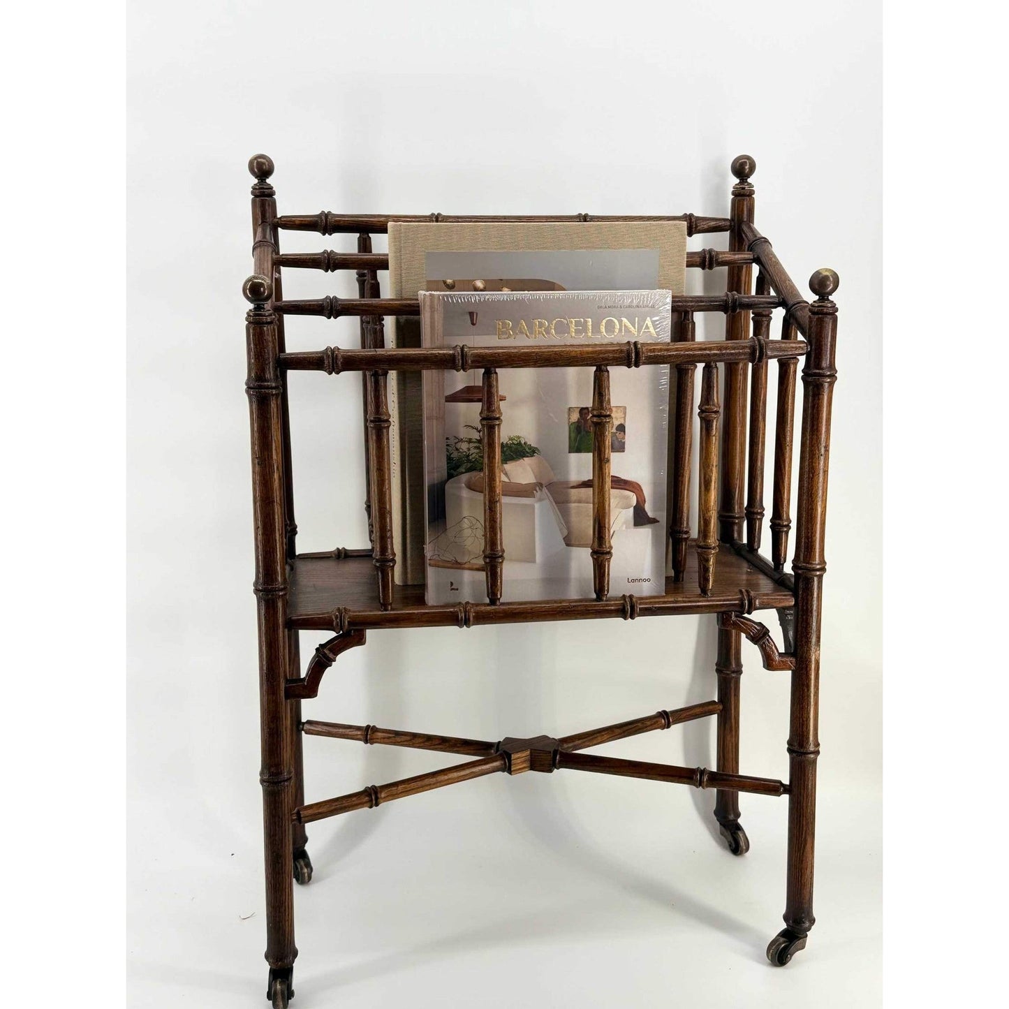 Vintage rolling faux bamboo wooden magazine rack with mid-century turned oak design