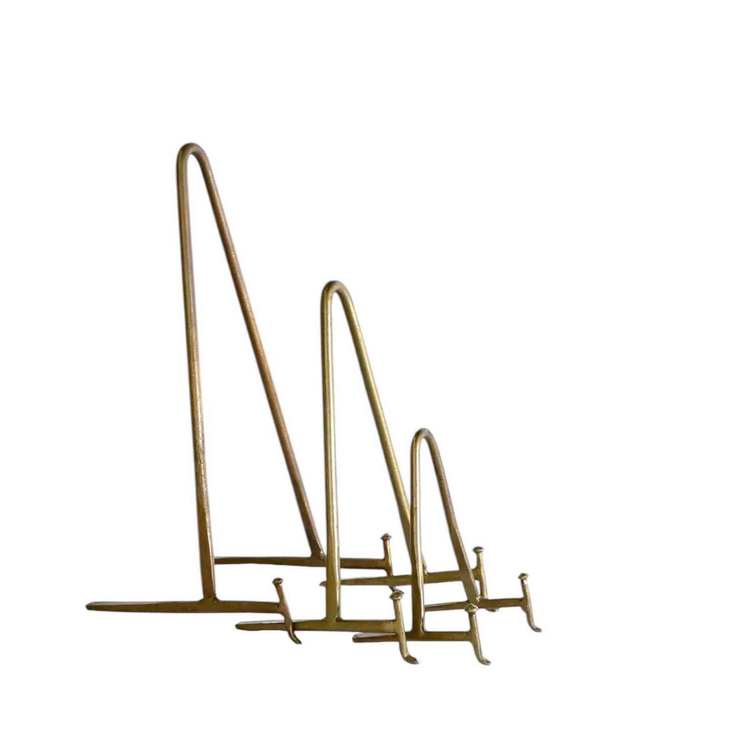 Set of three antique brass display stands in small, medium, and large sizes for showcasing books, artwork, or decorative items with vintage elegance.