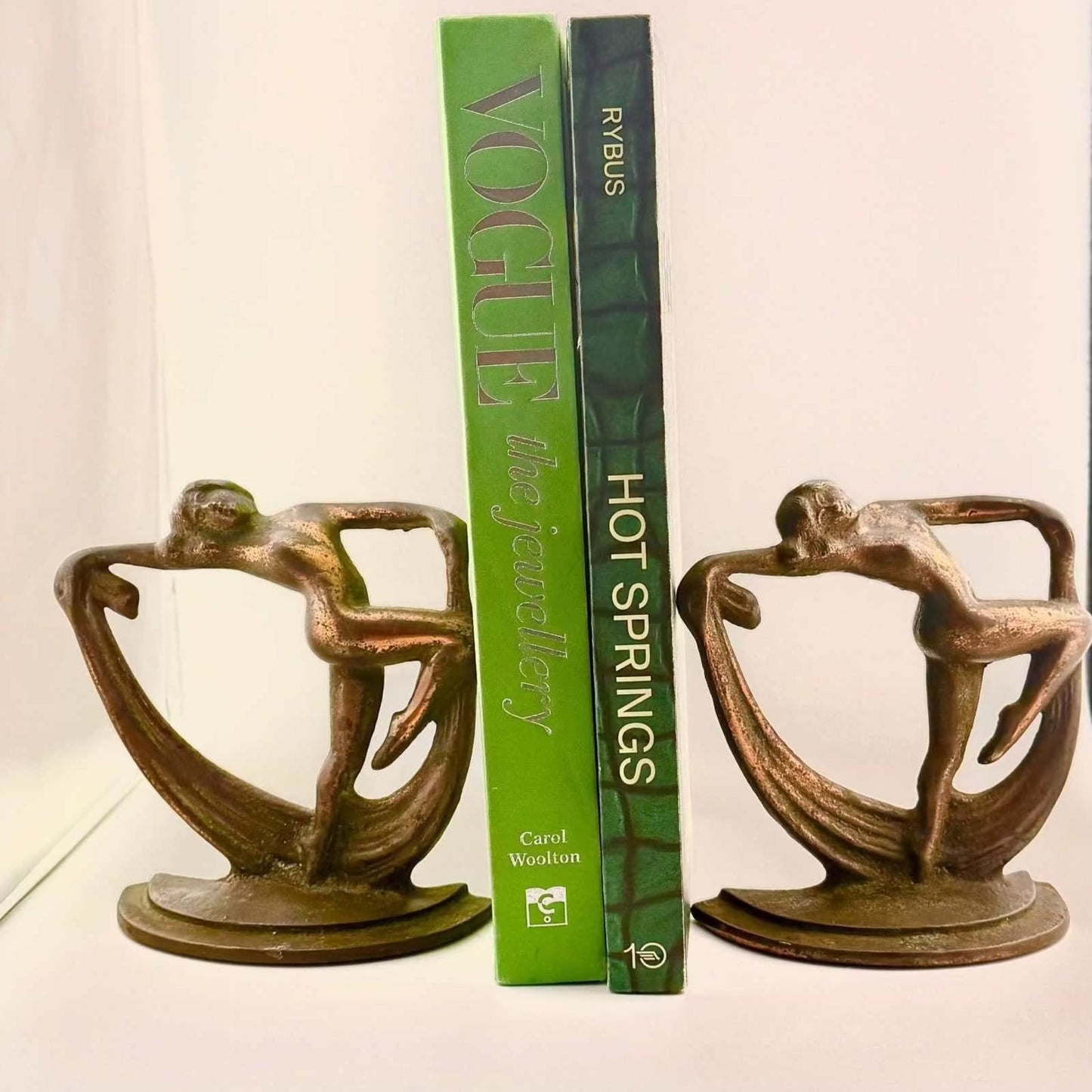 Art Deco sculptural bookends with original bronzed patina featuring dynamic athletic figures in cast metal