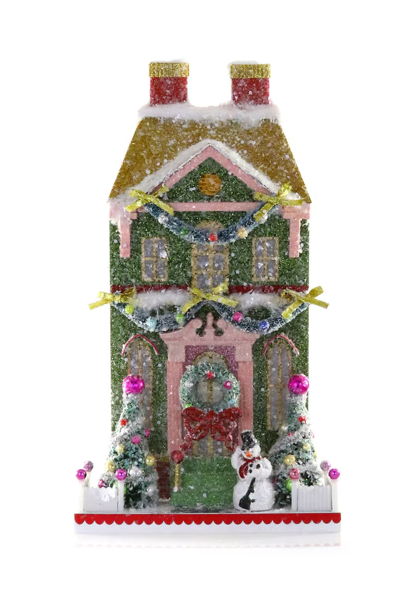 Snowman Manor decorative holiday house with snowman, garlands, bottlebrush trees, and festive wreath by Cody Foster