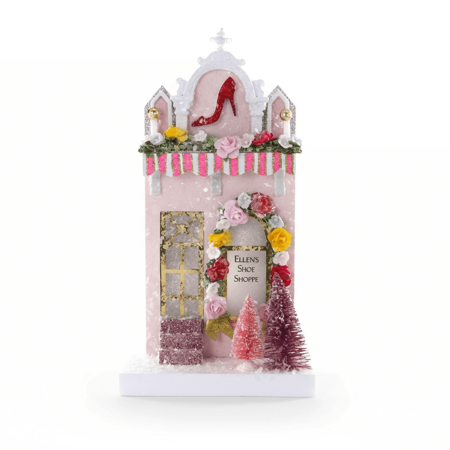Sugar & Spice Bake House pink holiday shop decoration with glitter, floral wreath, candy-striped awning, and miniature trees.