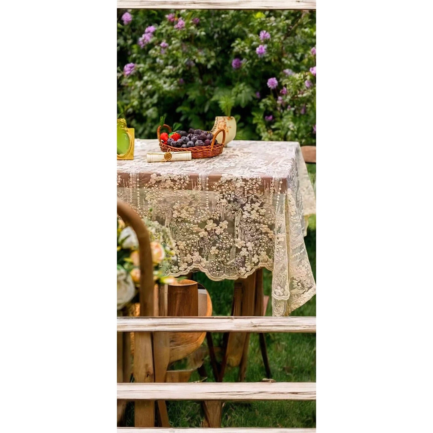 
                  
                    Vintage-style floral lace white tablecloth with intricate floral patterns on outdoor wooden table
                  
                
