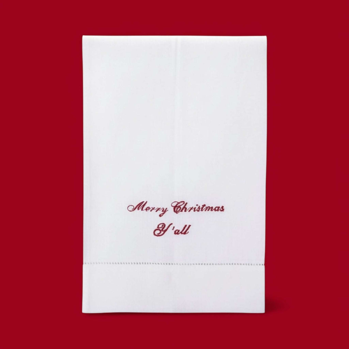 
                  
                    Christmas embroidered linen guest towel with "Merry Christmas Y’all" script on white cotton fabric
                  
                