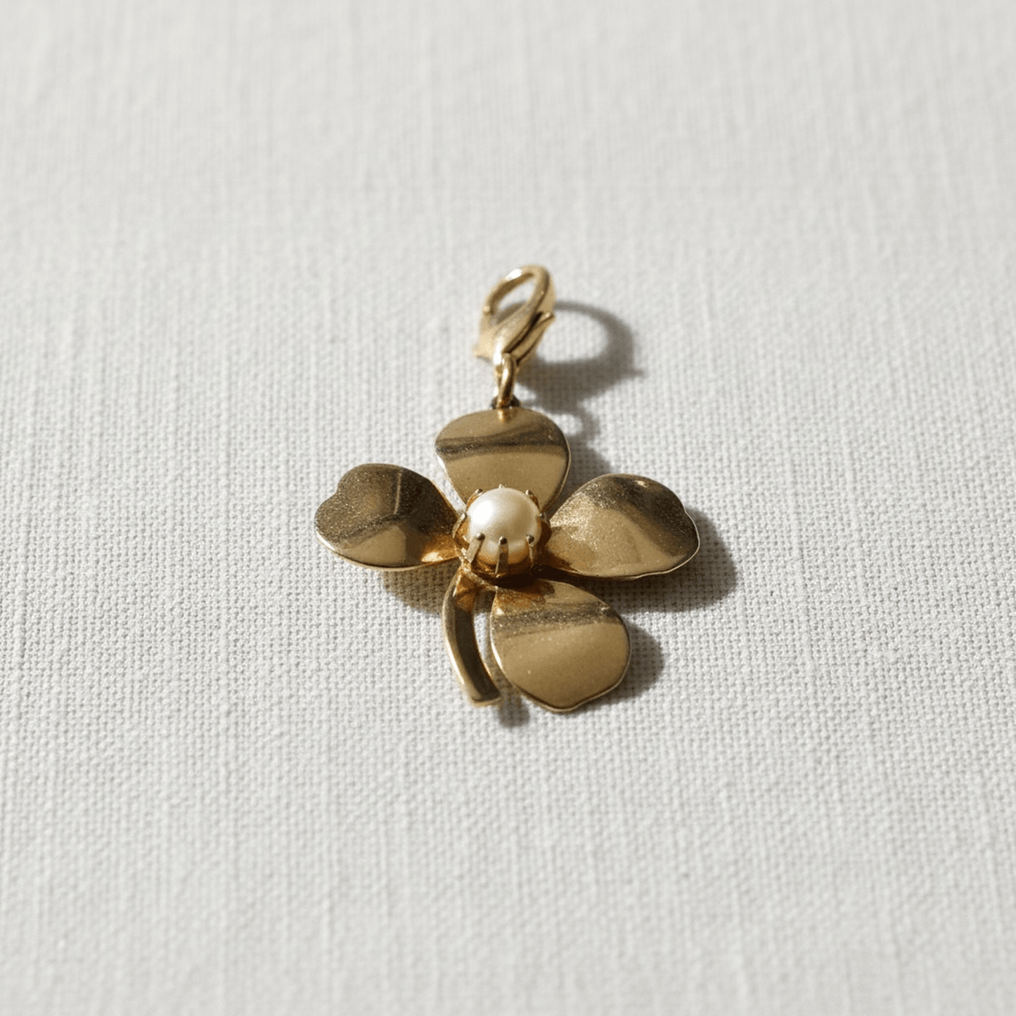 Vintage gold four leaf clover charm with pearl center and brass clasp