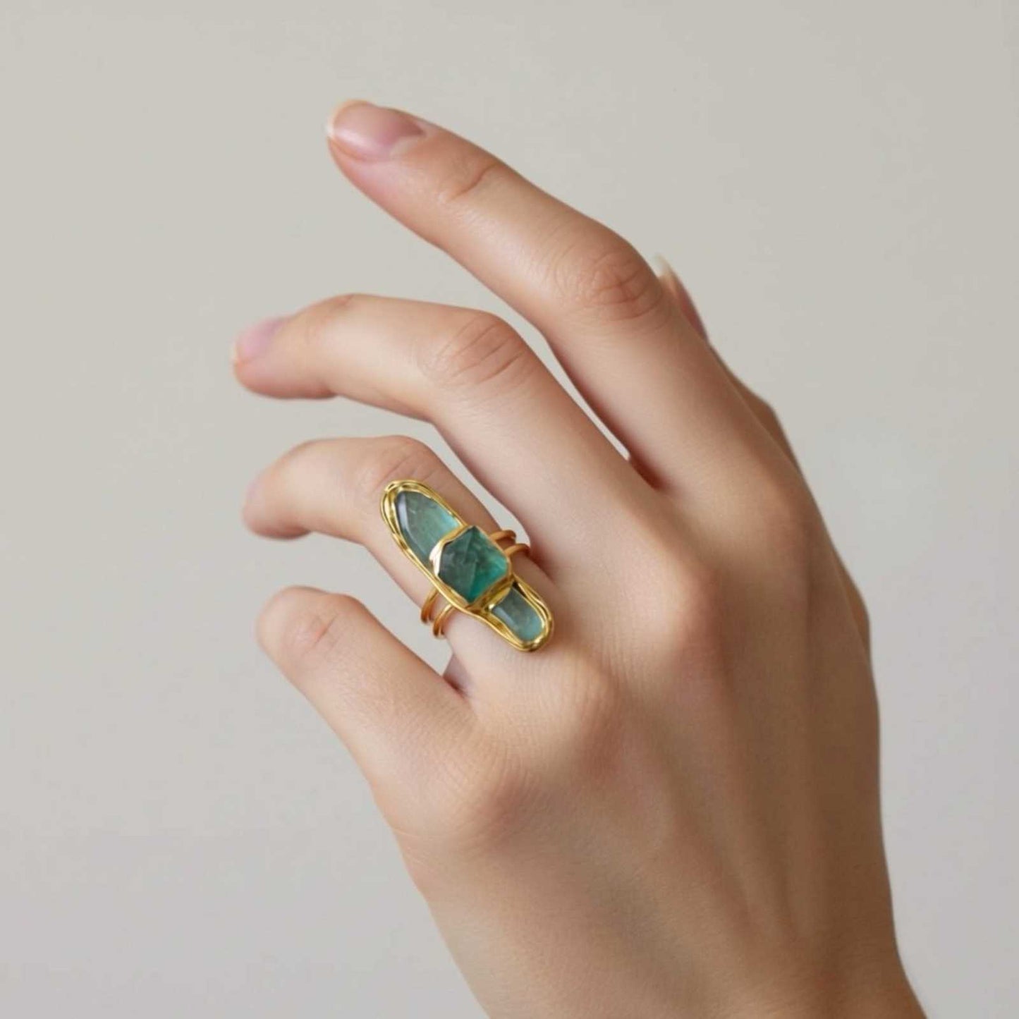 Adjustable statement gem ring with raw faceted stone in gold-tone setting