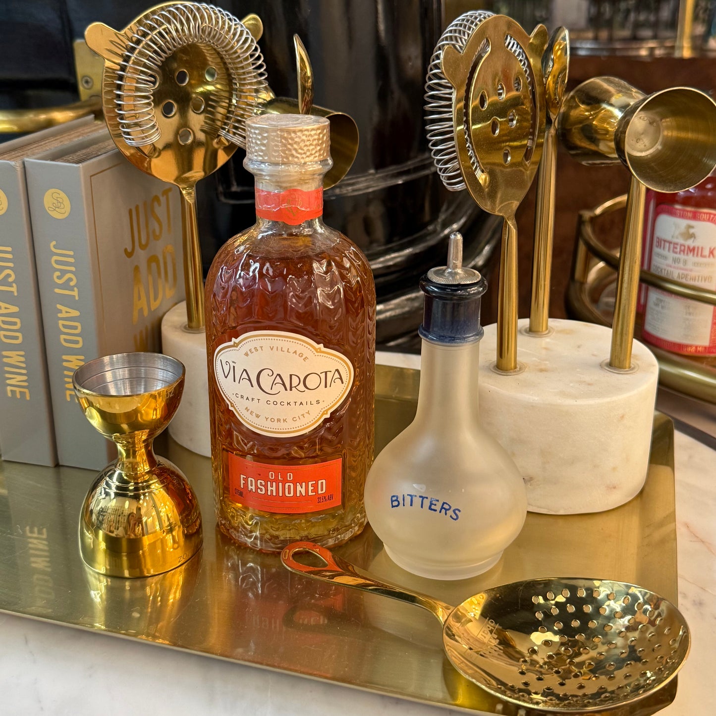
                  
                    Bitters bottle styled with barware and craft cocktail mix
                  
                