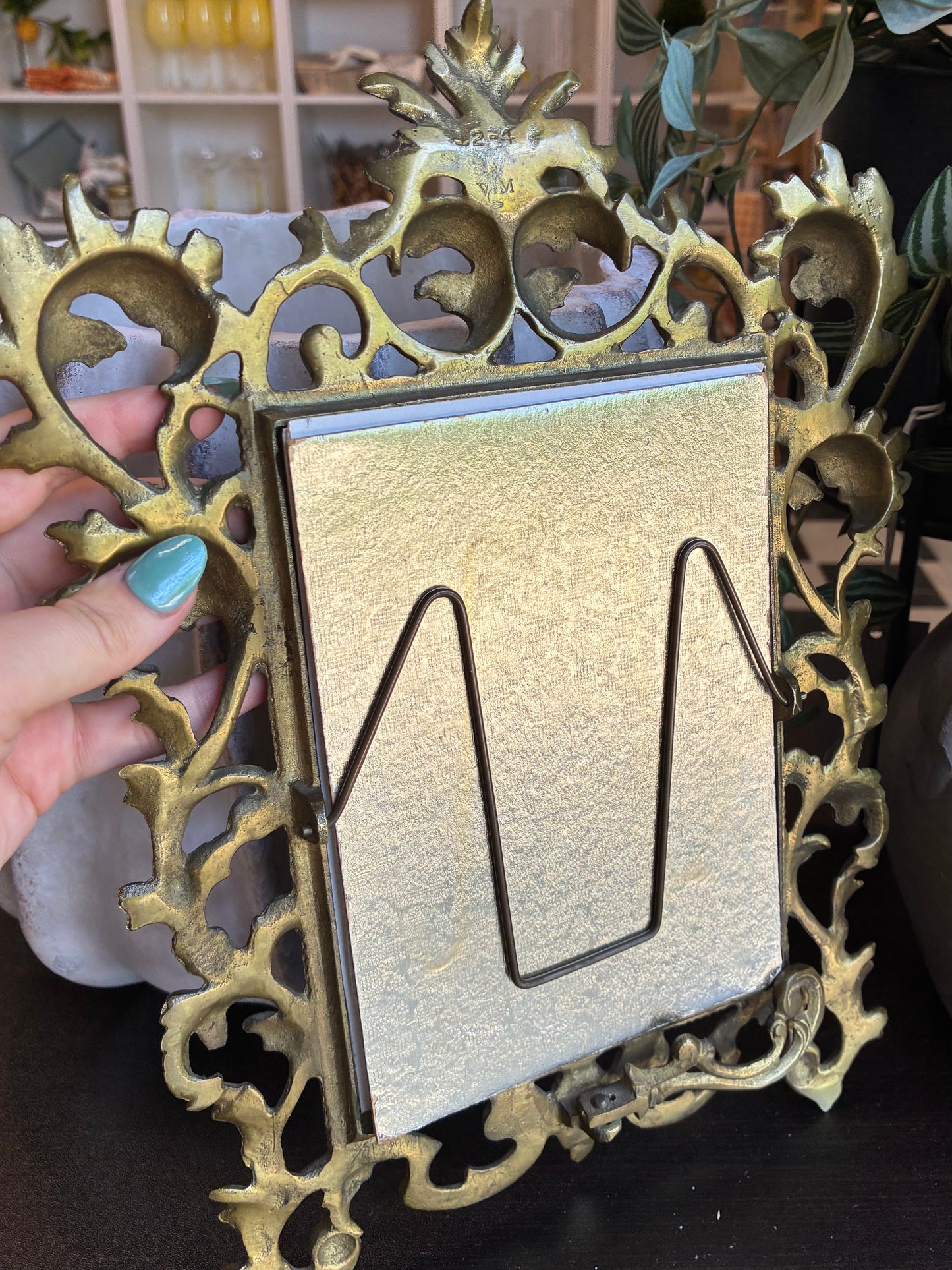 
                  
                    Back of gold ornate picture frame
                  
                