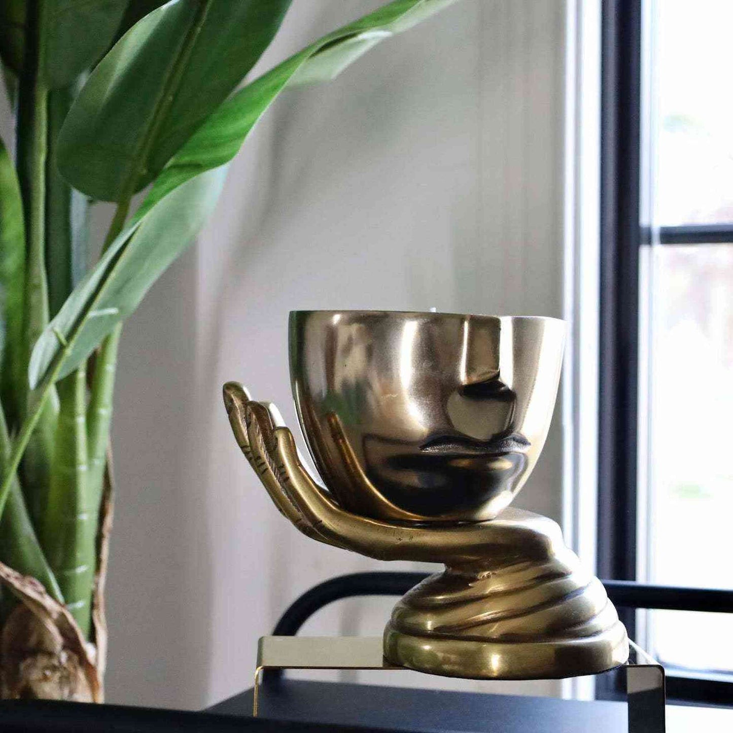 Iron Face Flames & Flannel Soy Candle in cast metal half-face design with triple wicks on a hand-shaped base