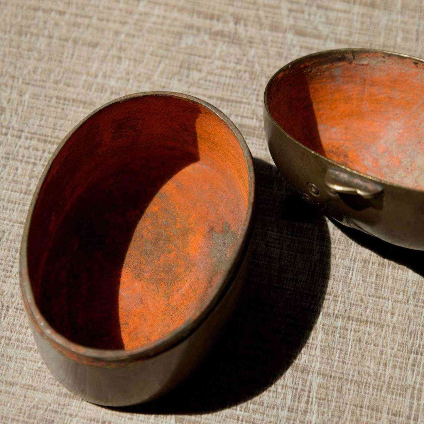 Antique Indian brass lady face box with original red kumkum pigment storage and intricate aged patina