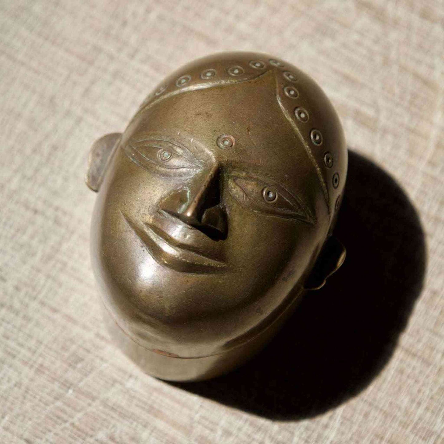 Antique brass lady face box from India with original red pigment for kumkum storage