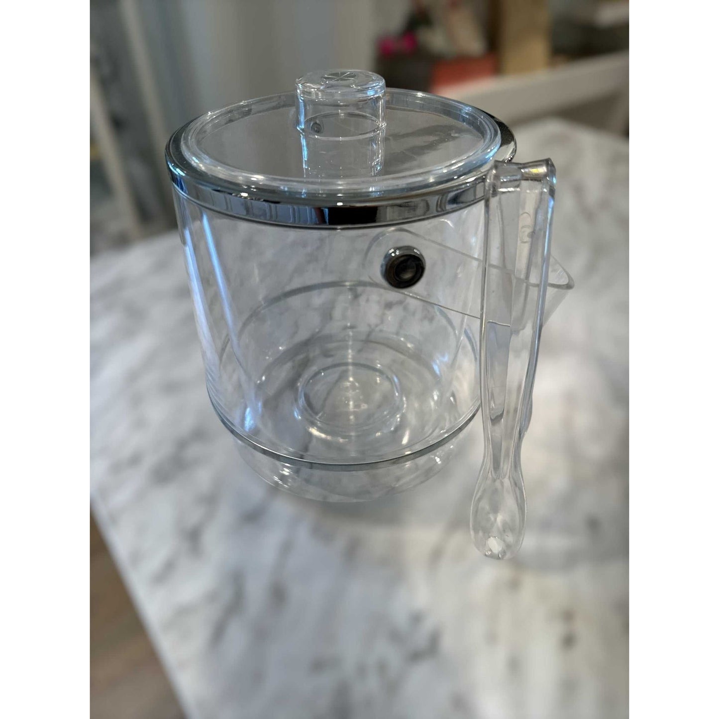 Vintage Lucite Ice Bucket with lid, handle, and tongs on marble surface