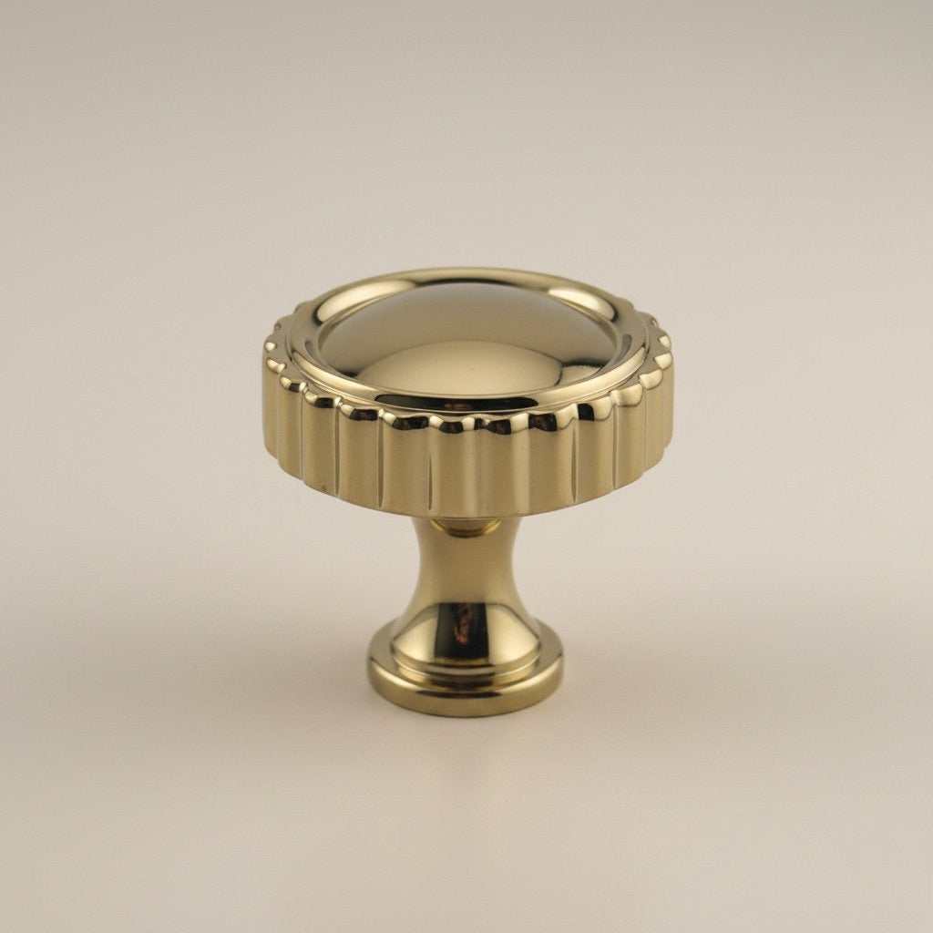 Classic brass spindle pull with fluted vertical detailing and polished gold finish
