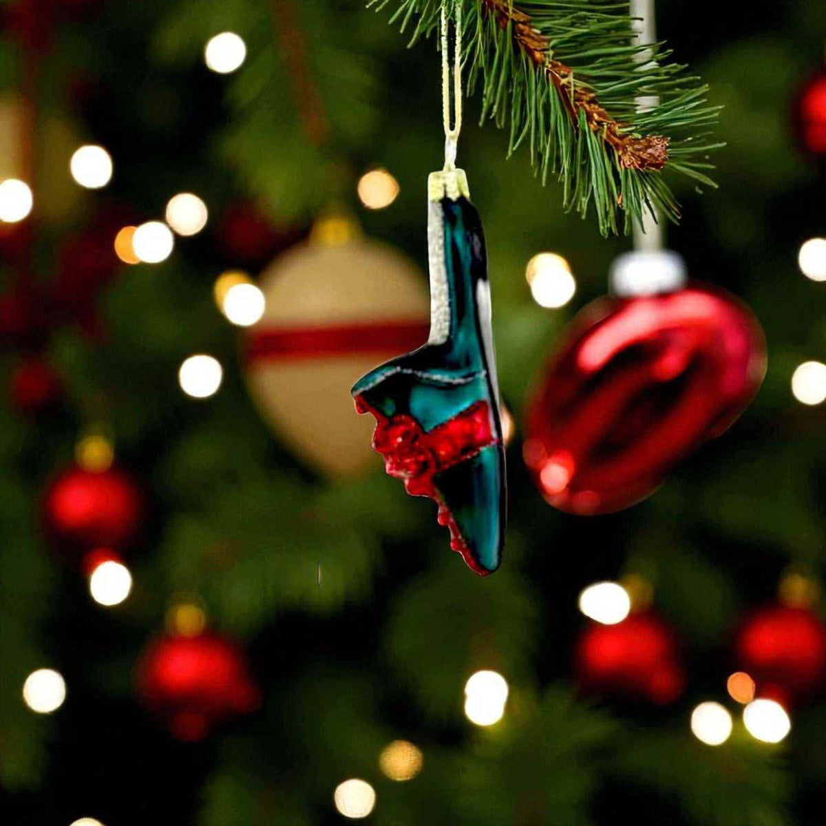 
                  
                    All Wrapped Up Shoes blown glass Christmas ornament shaped like festive boots hanging on tree
                  
                
