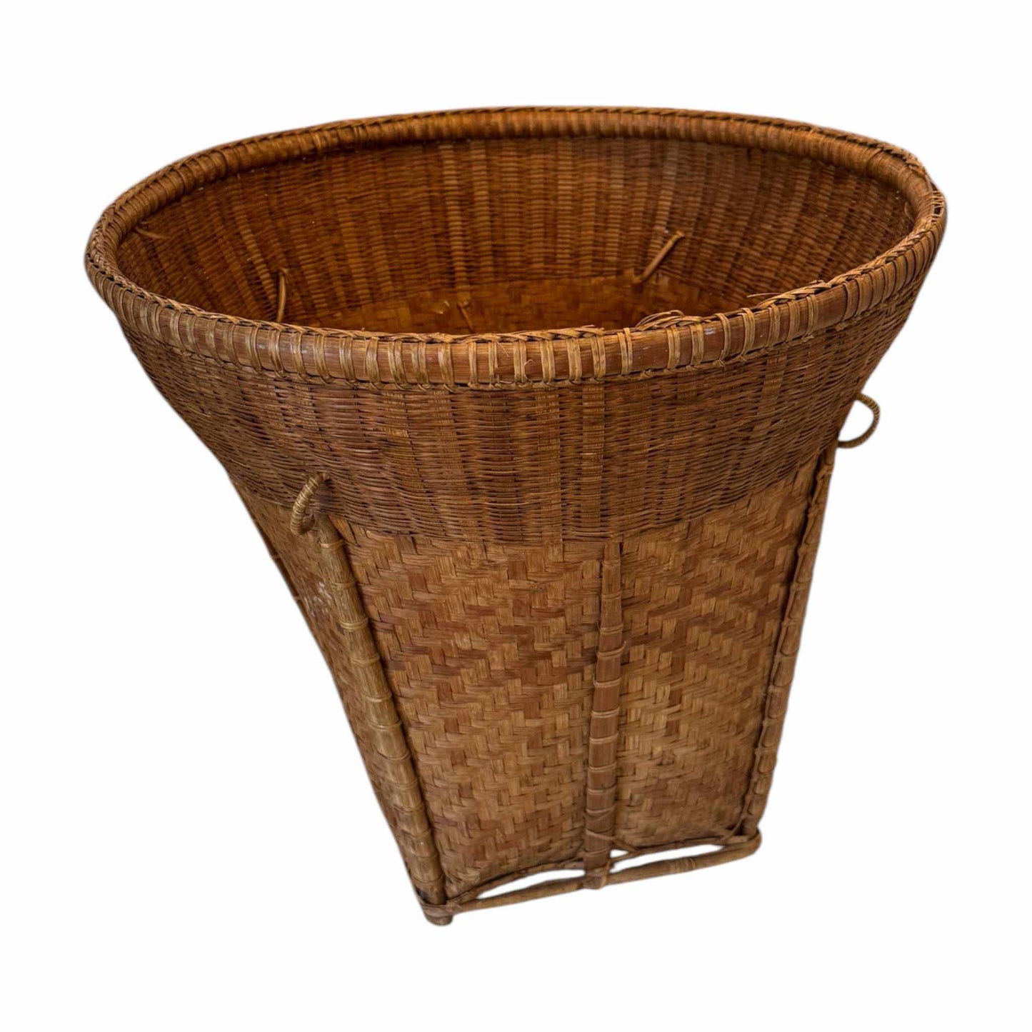 Vintage handwoven rattan basket with unique tapered silhouette and natural patina.