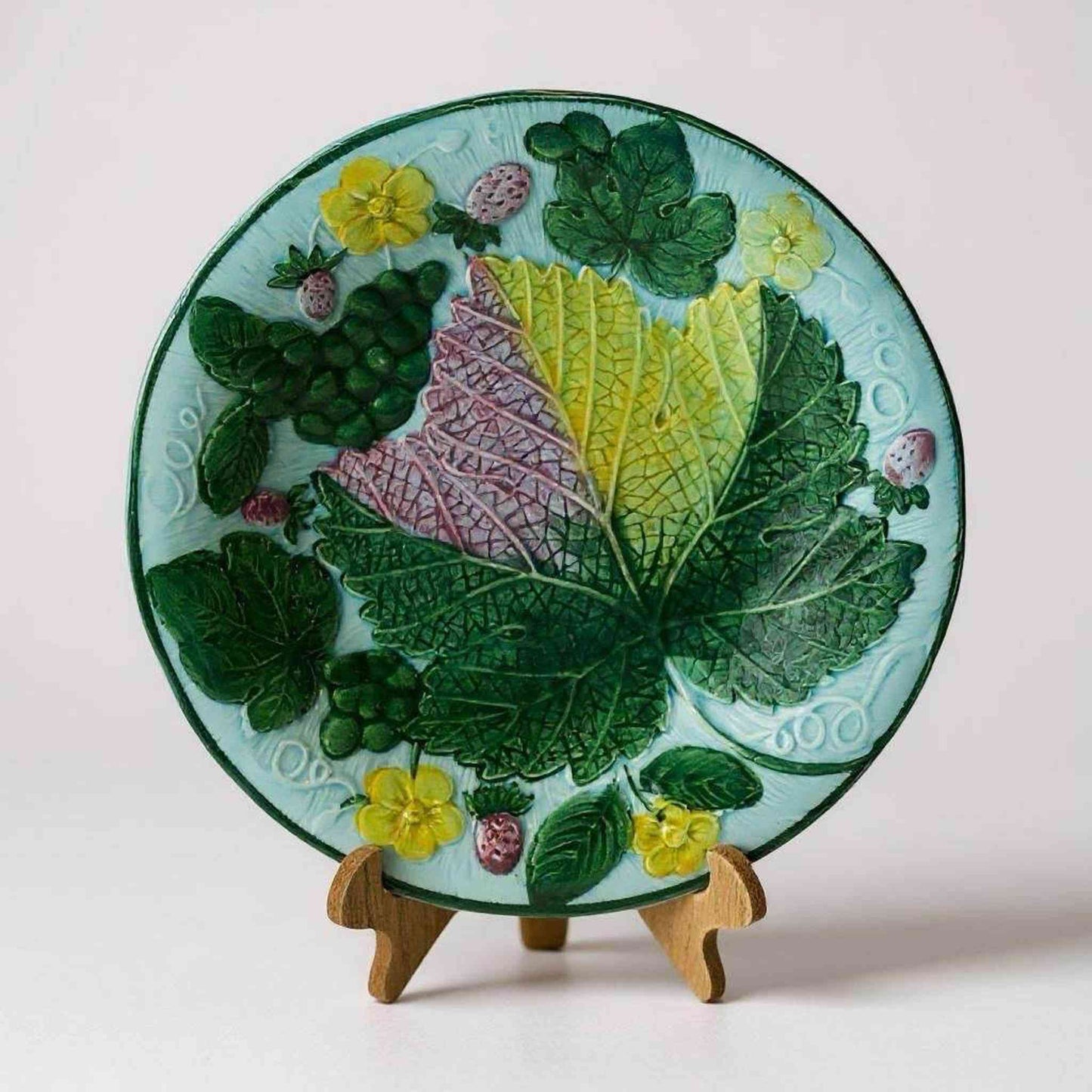 
                  
                    Vintage Majolica Grape Leaf Plate with raised grape and leaf design in vibrant colors on a 9-inch glazed ceramic plate
                  
                