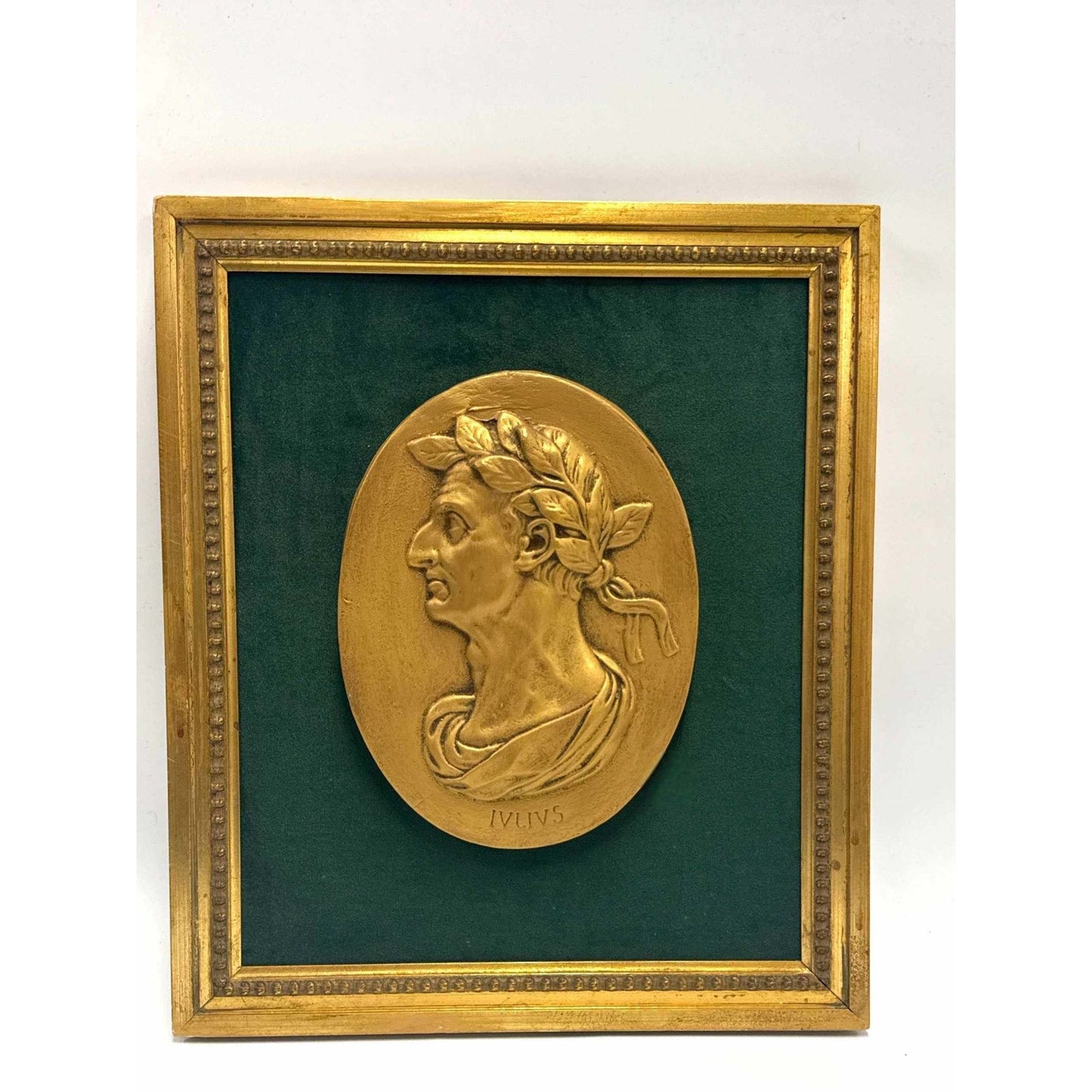 Framed bas-relief medallion of Julius Caesar in gold with laurel wreath on green velvet background and ornate gilt frame