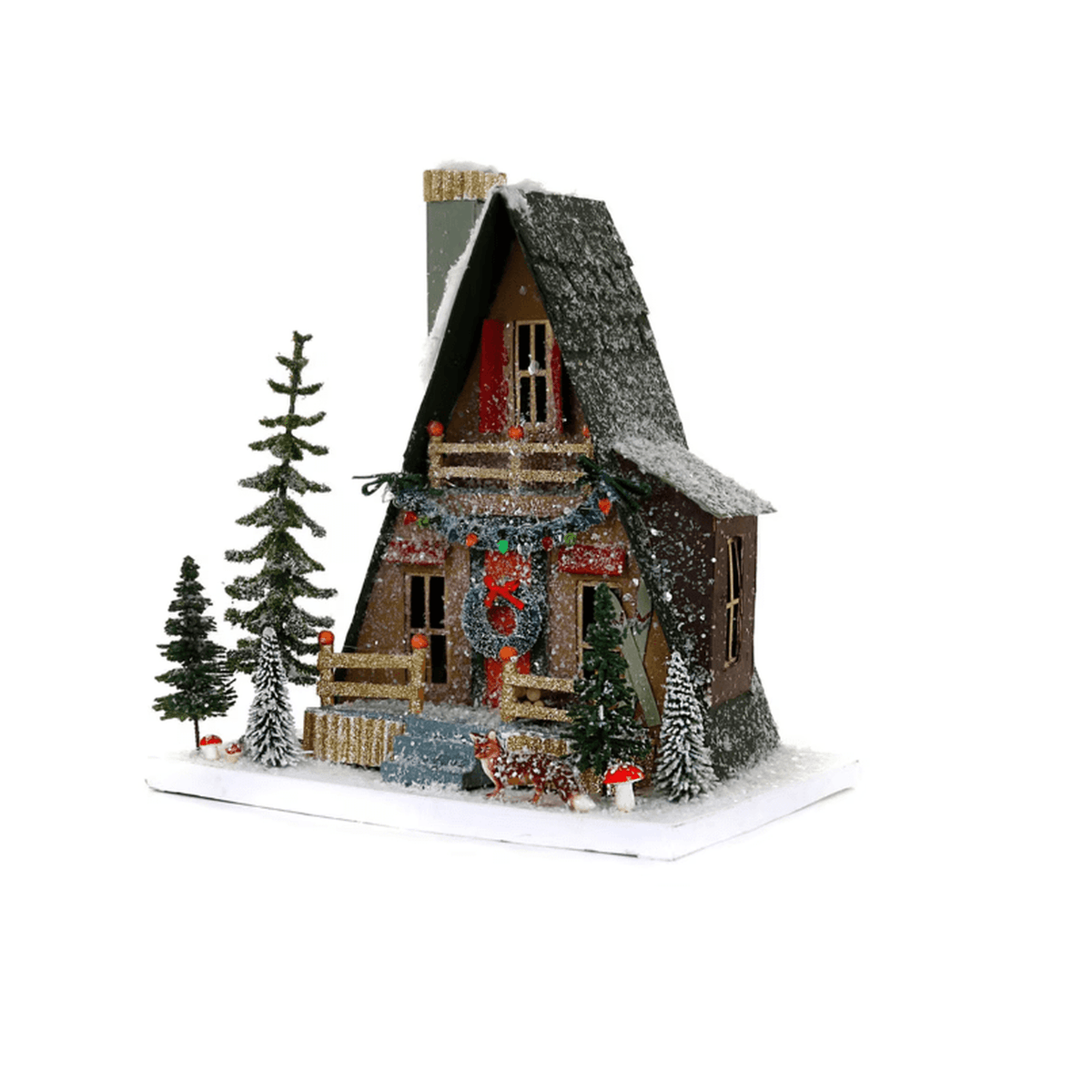 
                  
                    Hand-crafted A-Frame Cabin village house with glittered details, pre-lit windows, bottle-brush trees, and snowy holiday accents by Cody Foster & Co.
                  
                