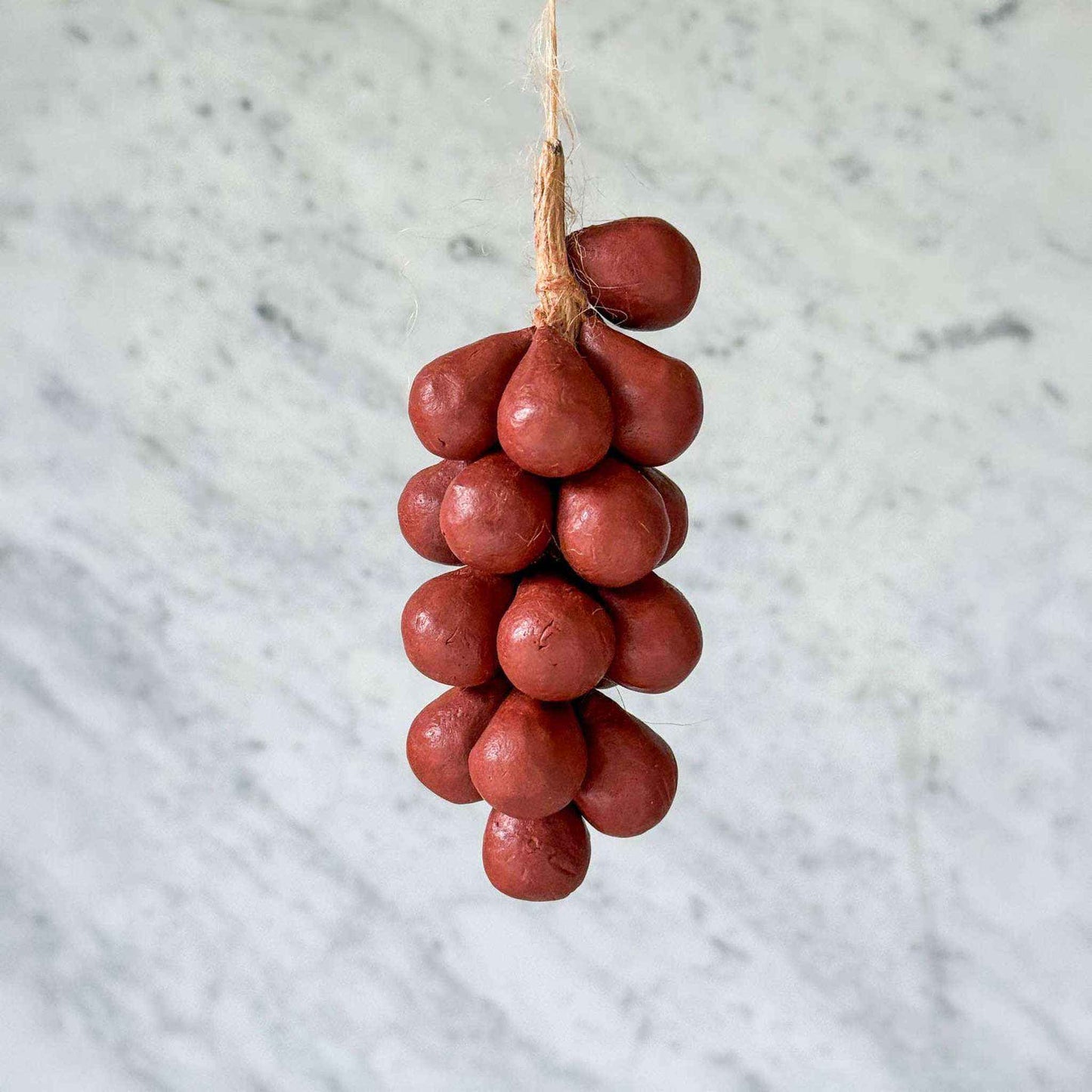 Handcrafted grapes soap made from 100% olive oil hanging by string with wine-colored grapes design