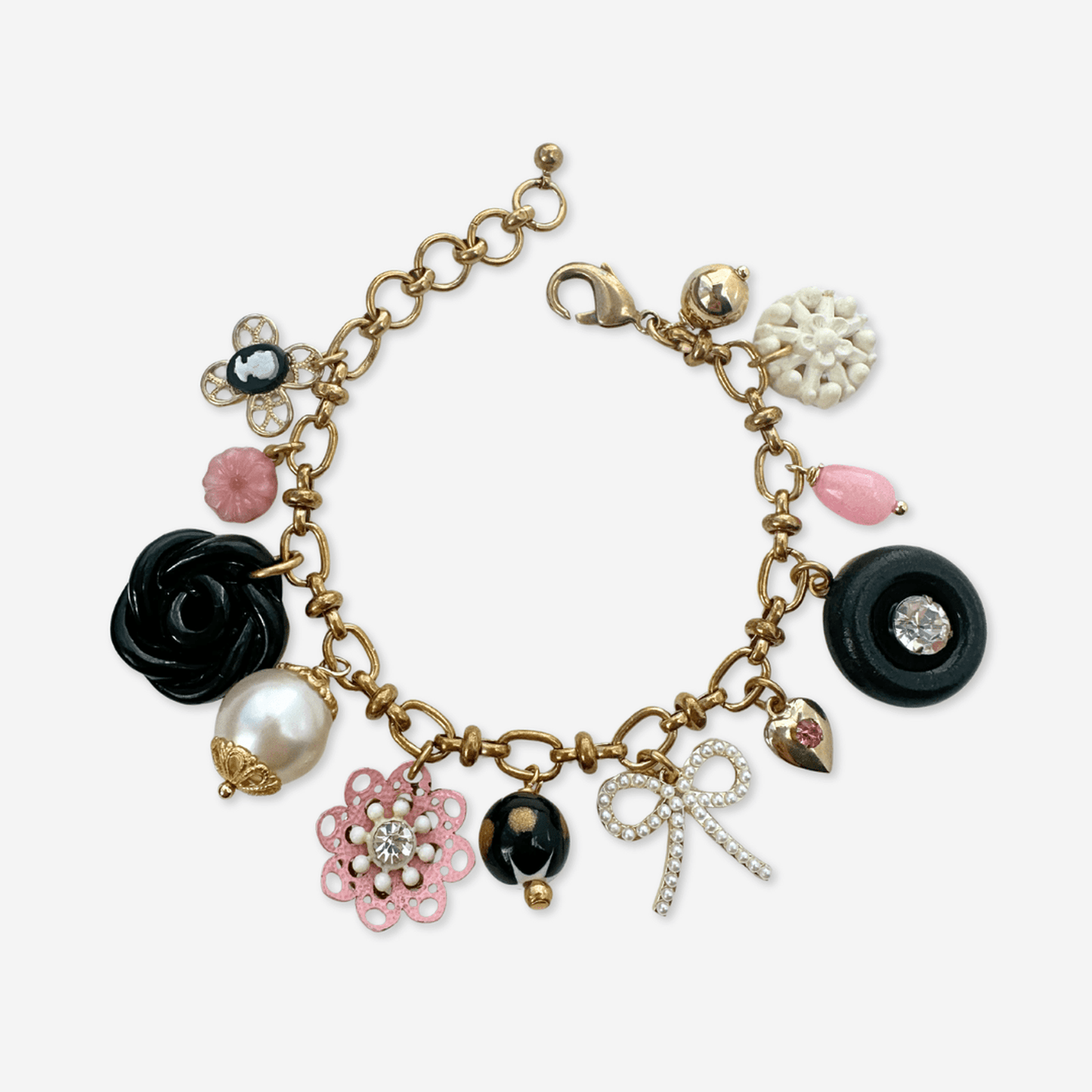 Repurposed vintage charm bracelet with pink, black, and white beads on adjustable brass chain