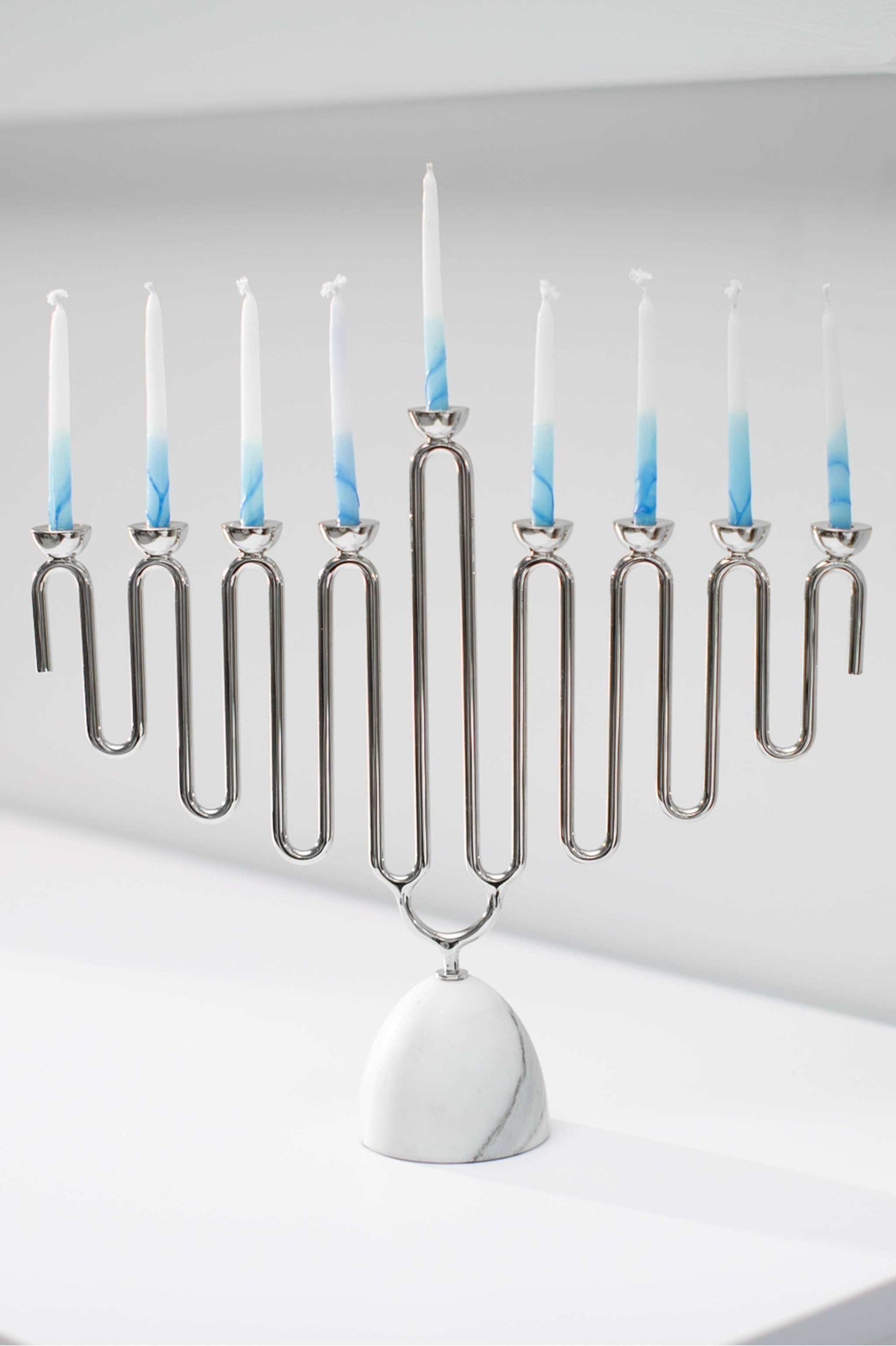 Coluna Menorah made of Carrara marble base and silver nickel-plated metal with blue and white candles