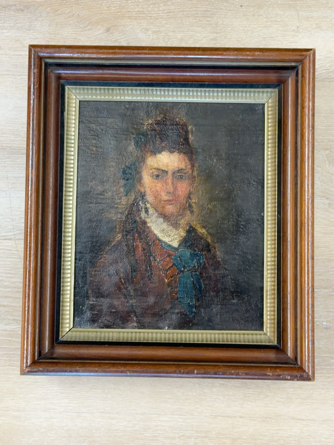 
                  
                    Full view antique oil portrait of a woman in carved wood frame with gilt liner
                  
                