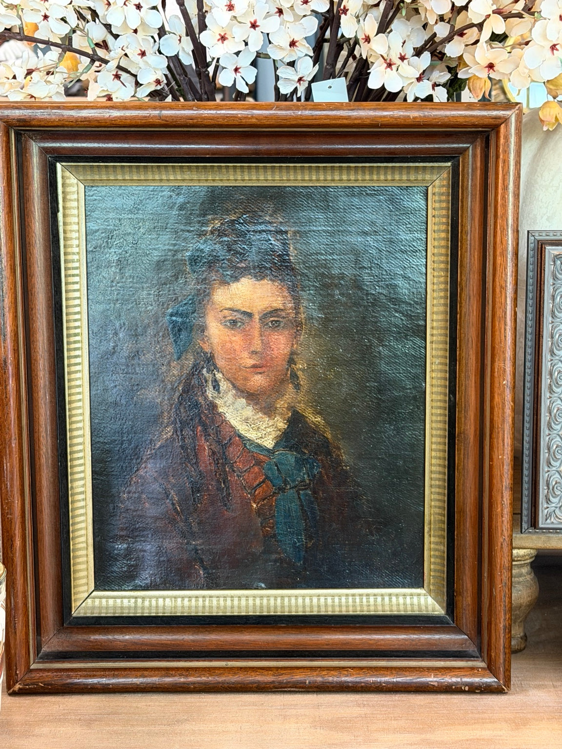 
                  
                    Antique framed oil portrait painting of a woman with blue bow
                  
                