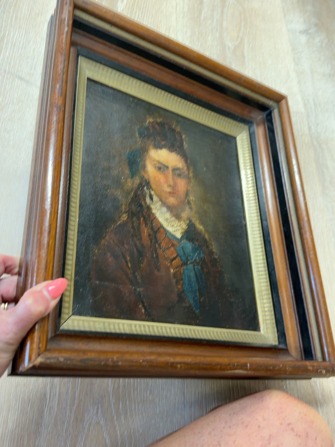 
                  
                    Angled full view of antique framed woman portrait showing substantial wood frame
                  
                