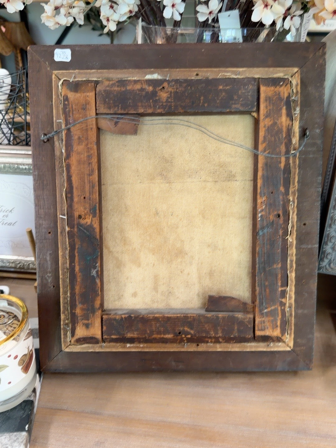 
                  
                    Back of antique framed oil portrait showing aged canvas stretcher and hanging wire
                  
                