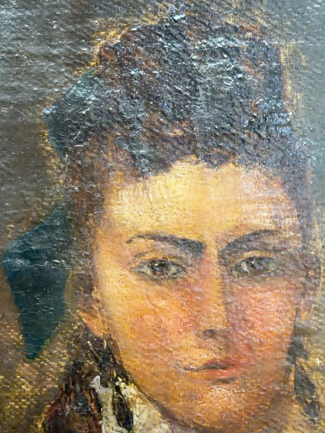 
                  
                    Face detail of antique oil portrait showing brushwork and craquelure
                  
                