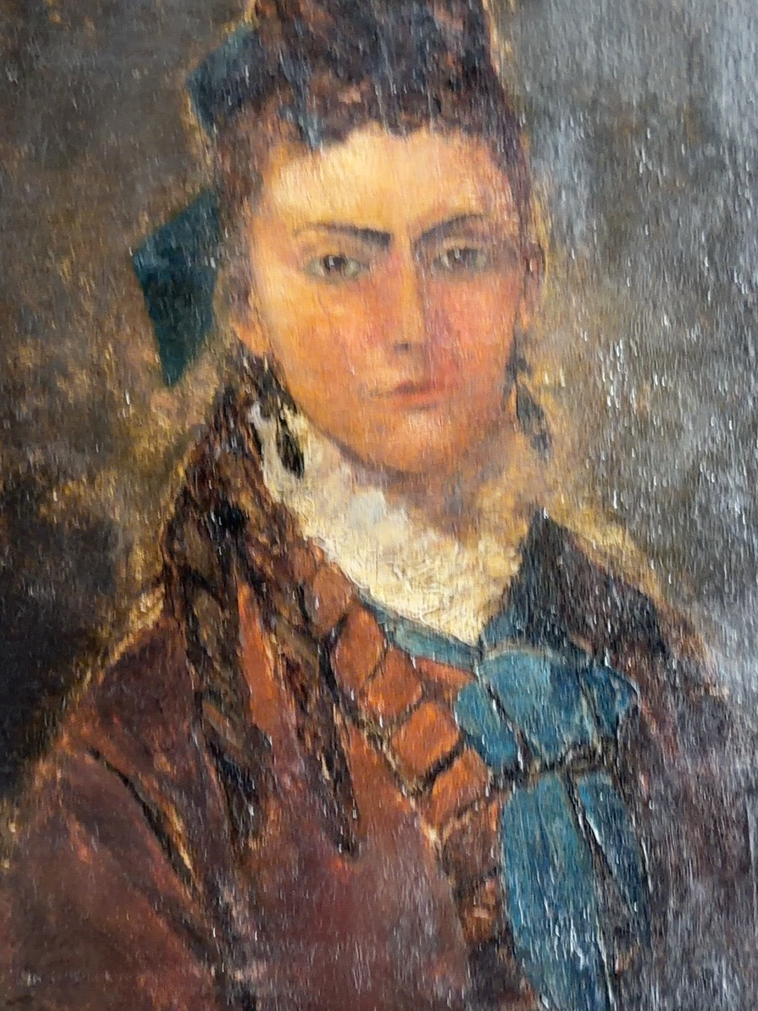 
                  
                    Detail of antique oil painting showing blue bow and textured painted surface
                  
                