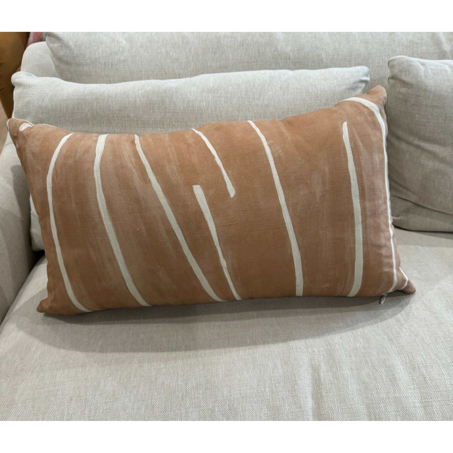 Kelly Wearstler Graffito 14x18 salmon and cream decorative pillow with down insert on beige couch
