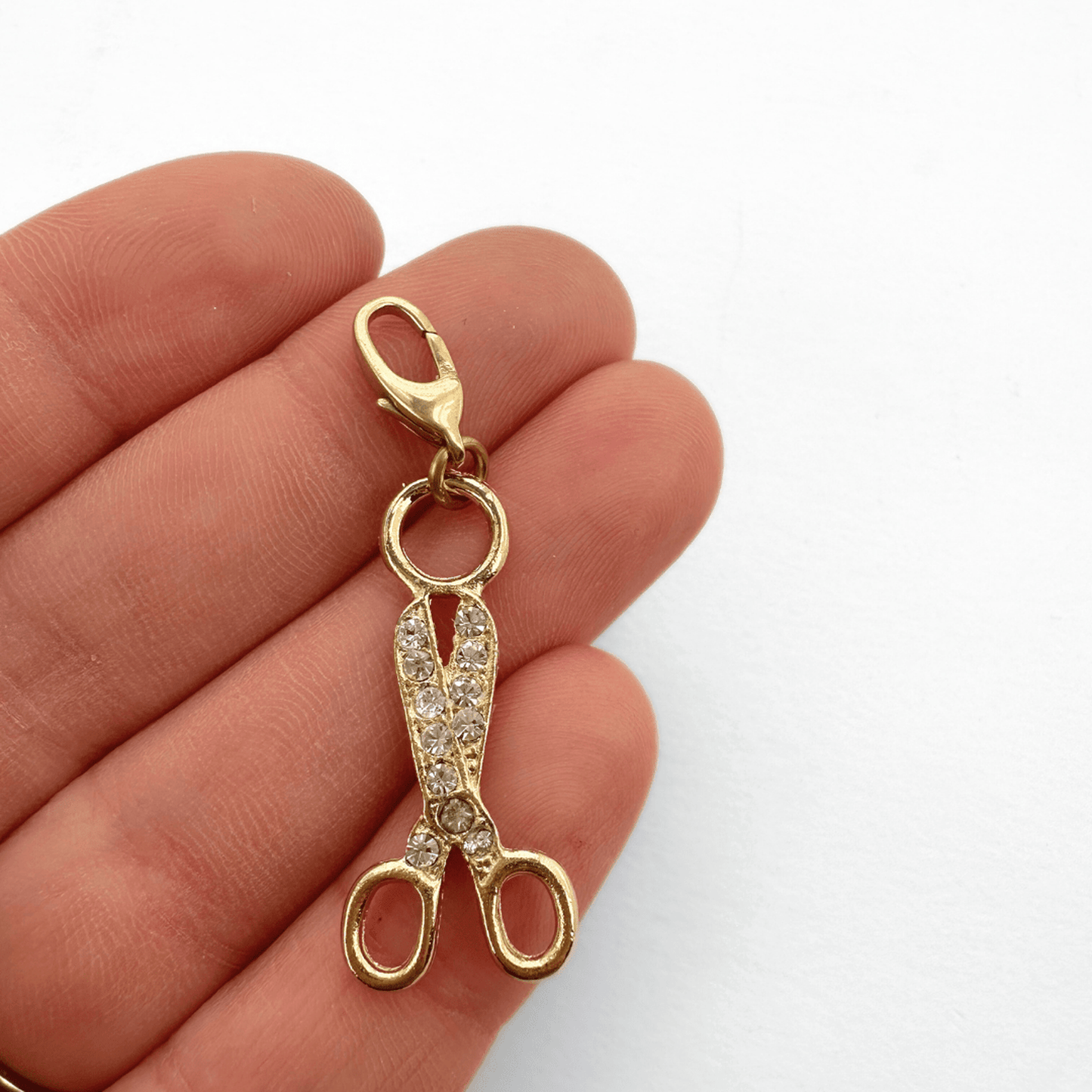 Vintage gold plated scissors charm with clear rhinestones and raw brass clasp