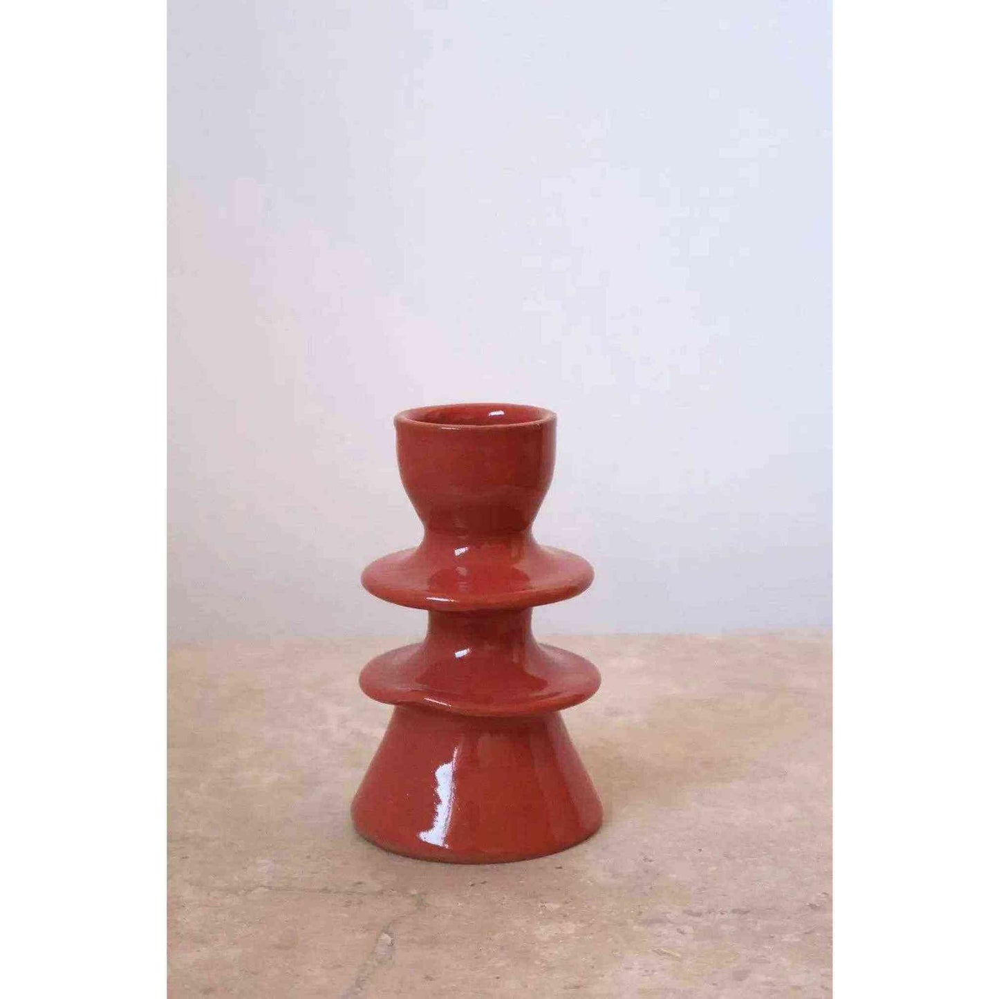 Handmade dark pink ceramic candle holder with glossy finish and unique artisanal design