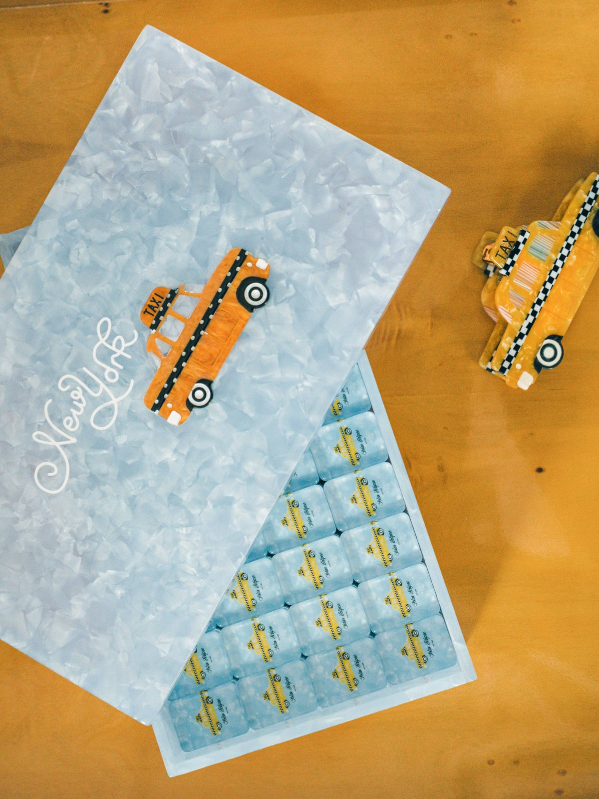 
                  
                    Open Solar Eclipse mahjong case showing taxi-print tiles in fitted trays
                  
                
