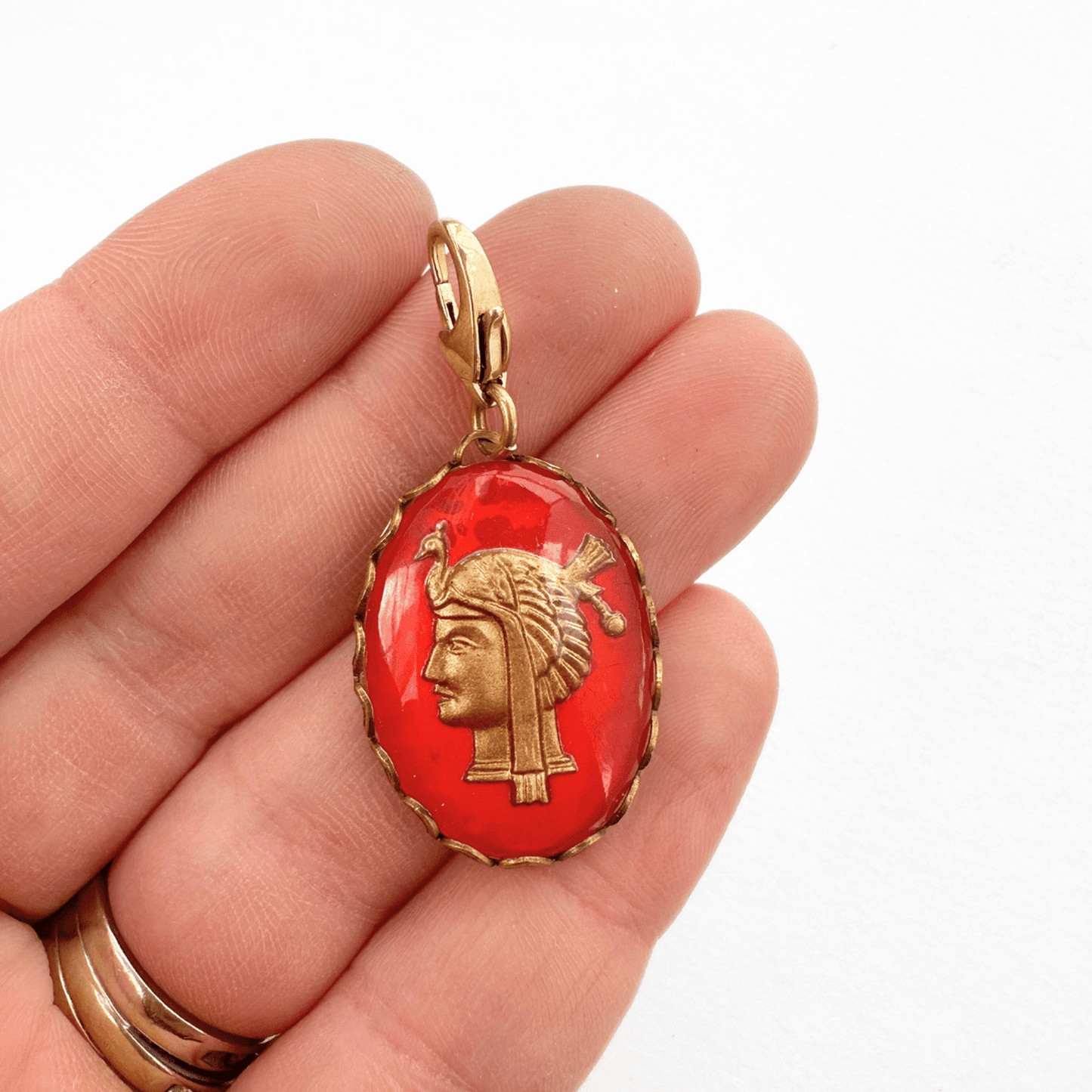 Vintage red and gold Egyptian intaglio charm with gold head on red oval glass and raw lace edge setting
