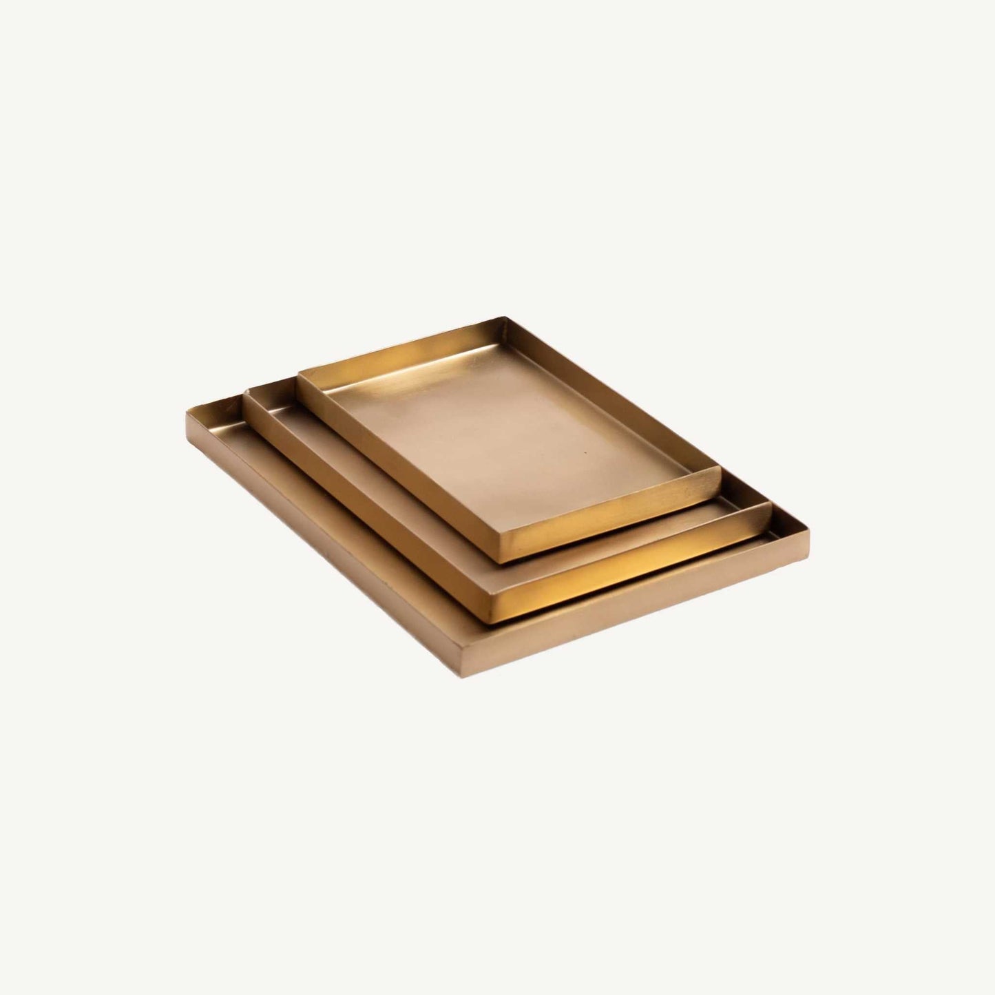 
                  
                    Set of 3 handcrafted brass rectangular trays with nesting design and elegant metallic finish
                  
                