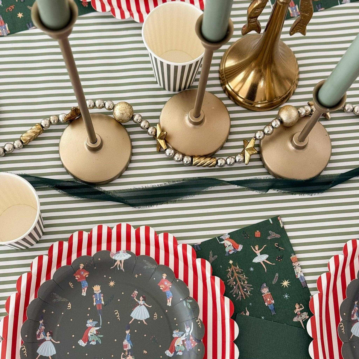 
                  
                    Green Christmas Nutcracker paper napkins with gold-foil accents on festive holiday table setting
                  
                