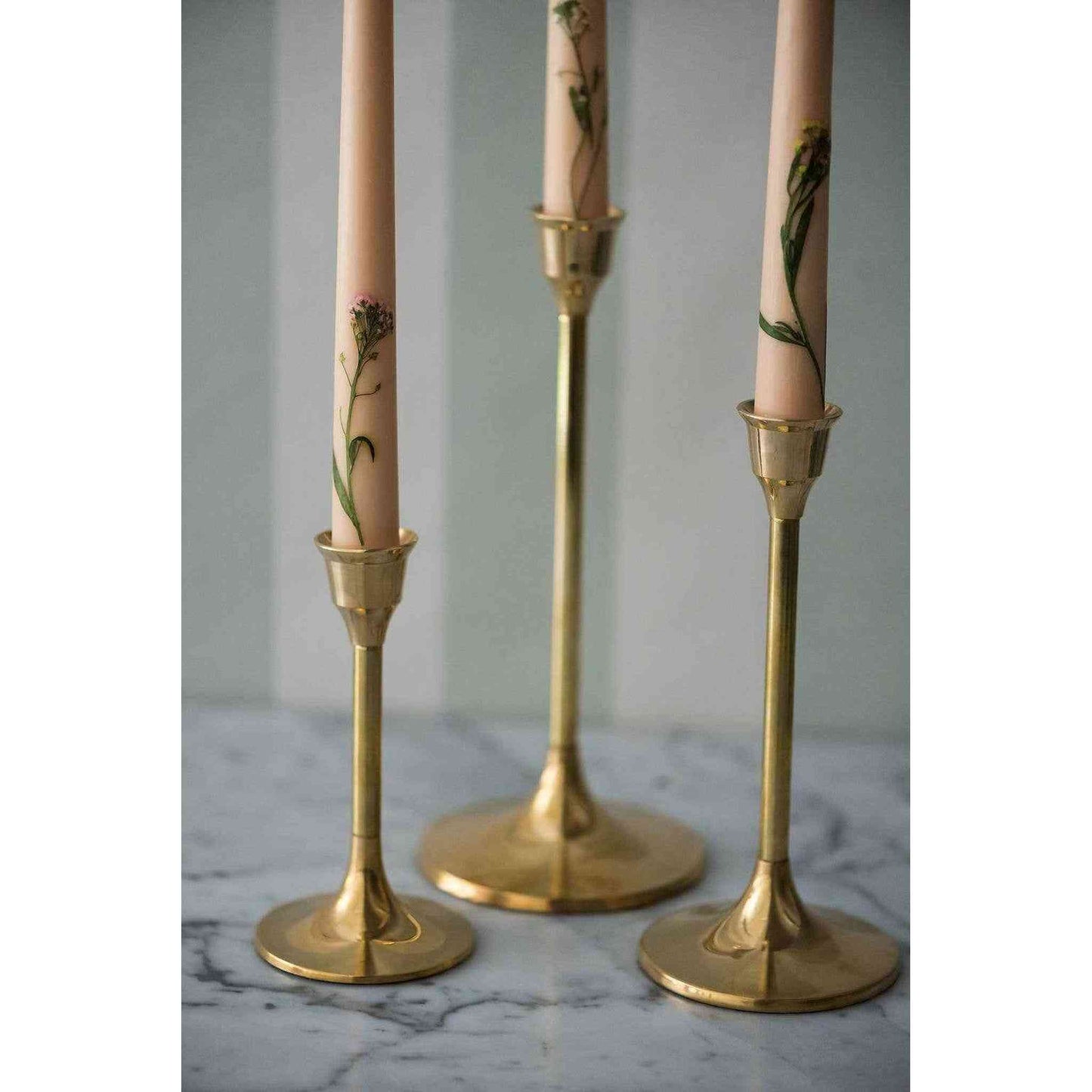
                  
                    A set of three brass candlesticks. - Curated Home Decor
                  
                