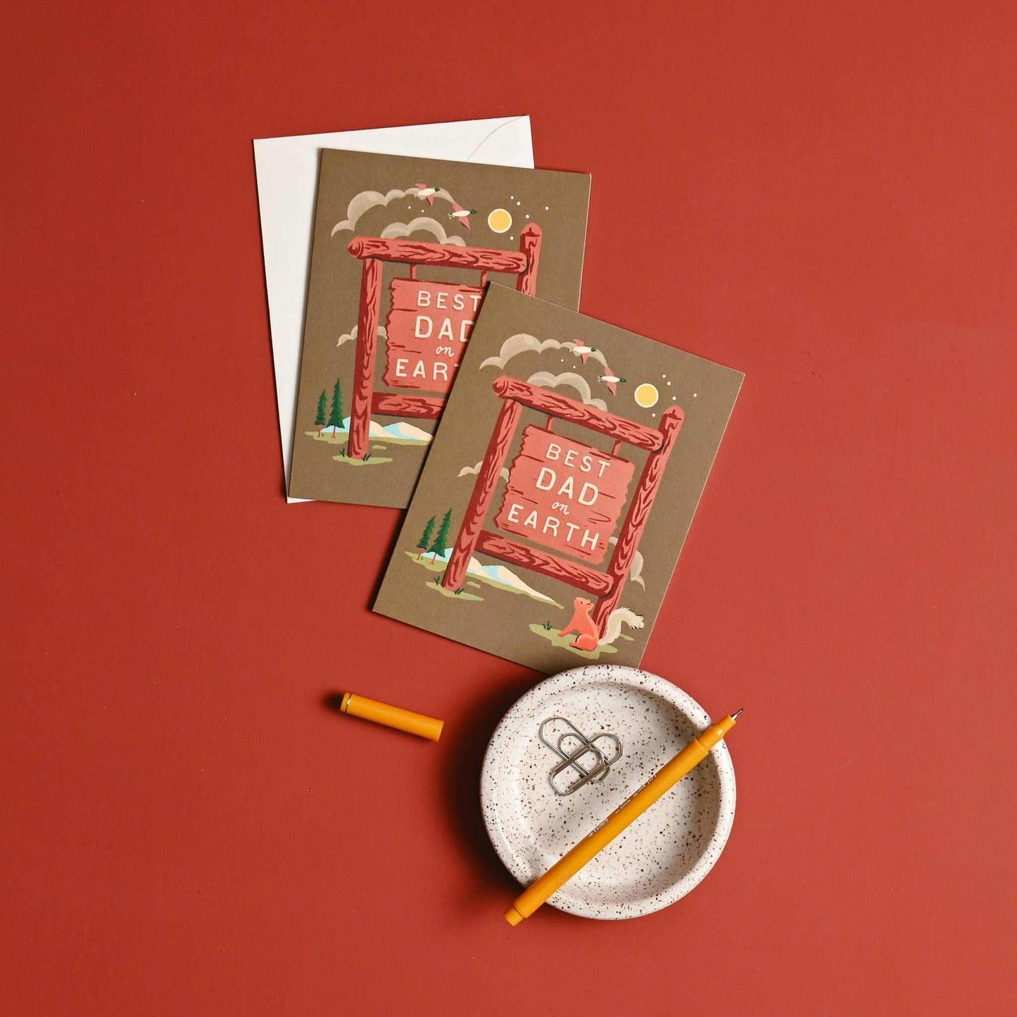 Best Dad on Earth Father's Day card with camp-inspired design and coordinating envelope on red background