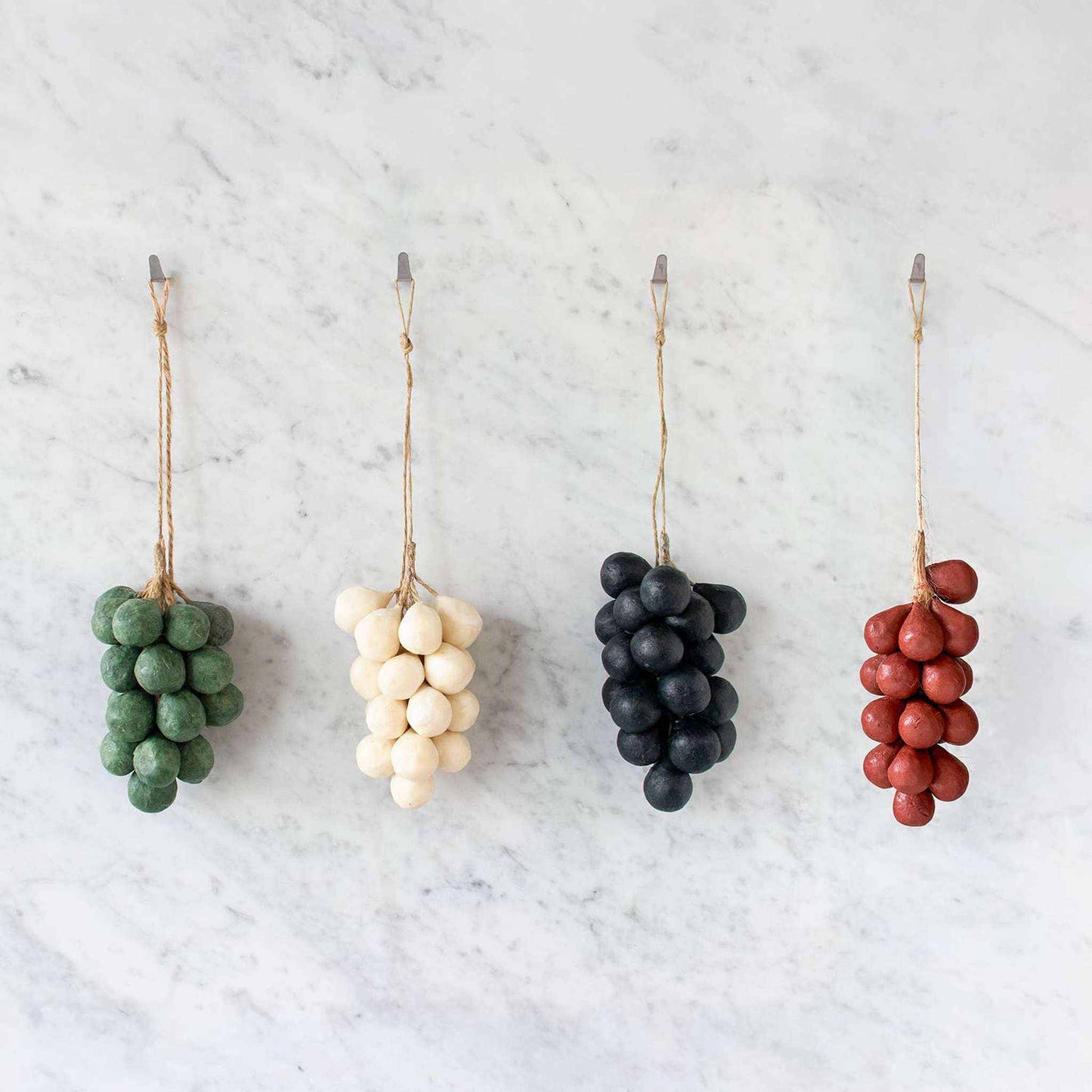 Handcrafted grapes soap bundles in green, white, black, and red hanging with strings for easy use and decoration, made from 100% olive oil and scented with jasmine.