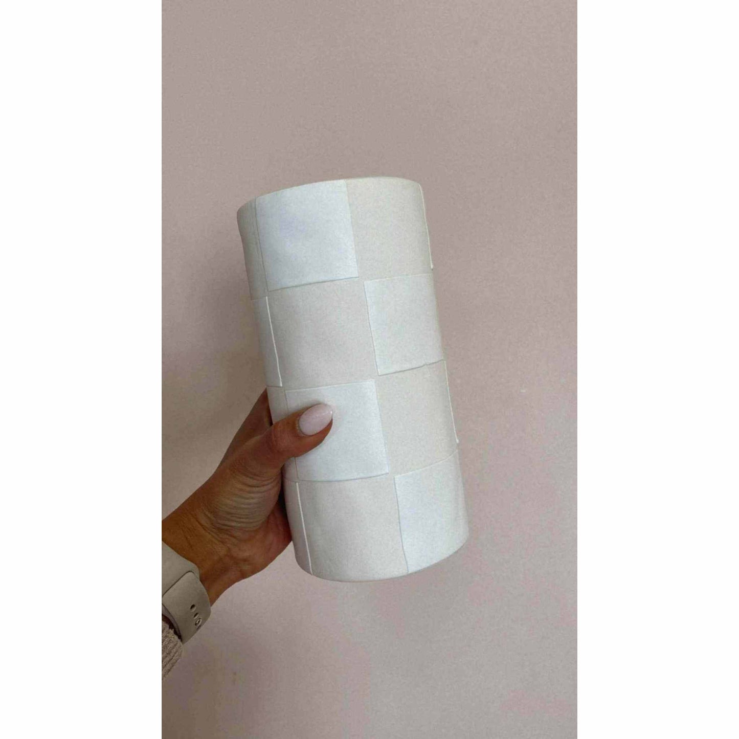 Checkmate Ceramic Vase textured white and cream ceramic flower vase held by hand against beige background