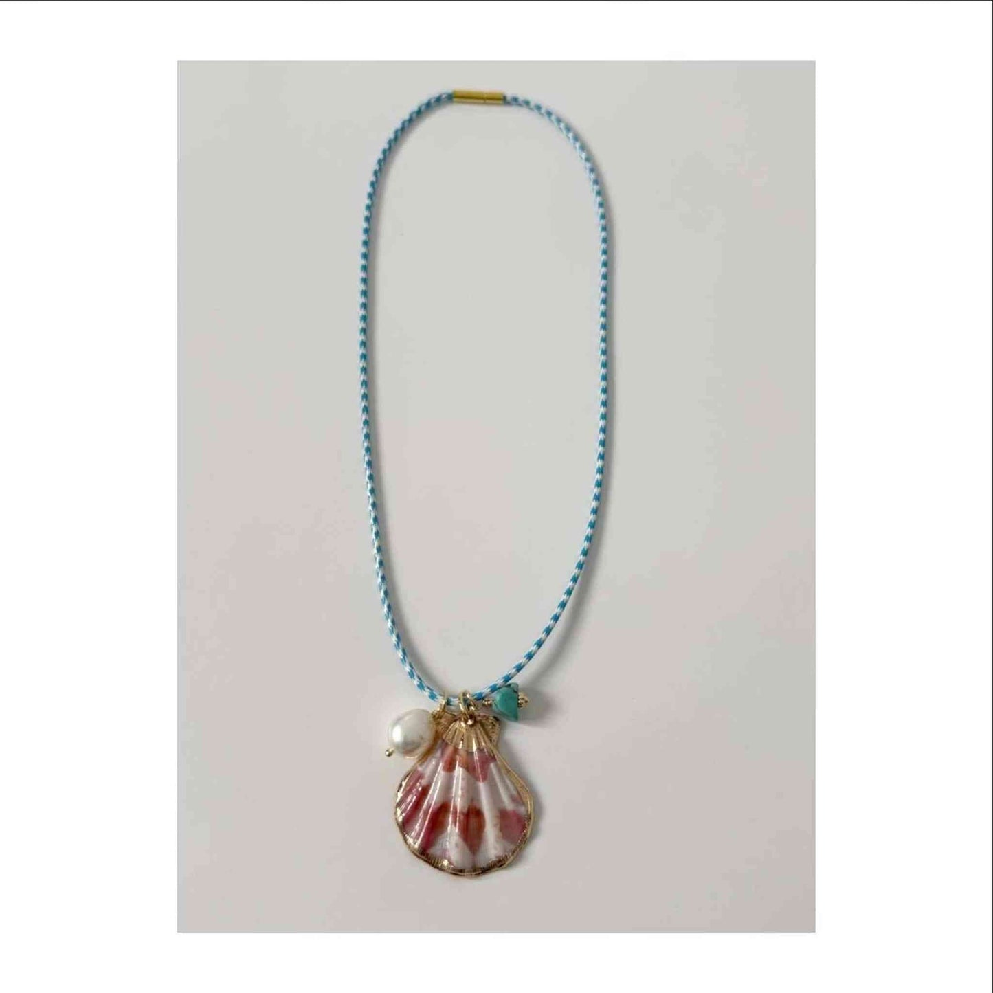 Islas Shell Necklace blue and white cord with gold plated shell, freshwater pearl, and turquoise charm, 16 inches long