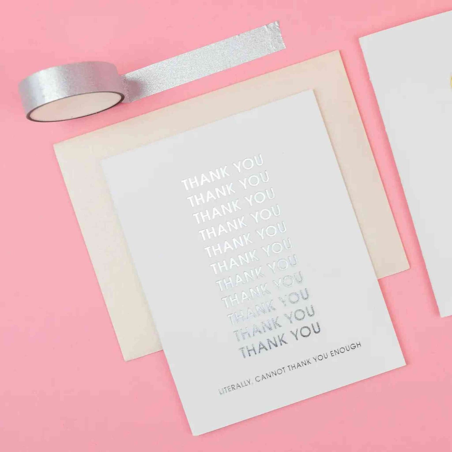 Literally Cannot Thank You Enough Card with silver foil text on bright white cotton paper and coral envelope on pink background