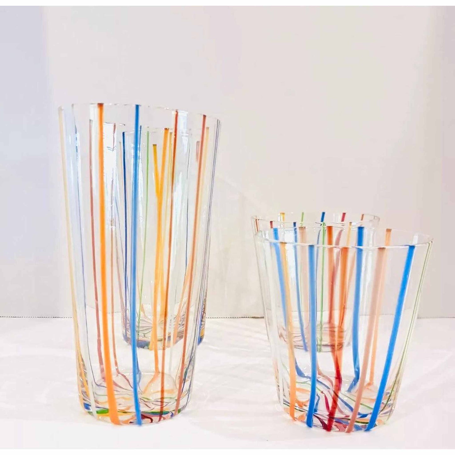
                  
                    Set of 4 Vintage Murano Style Italian glassware with colorful vertical stripes, including two short and two tall glasses.
                  
                