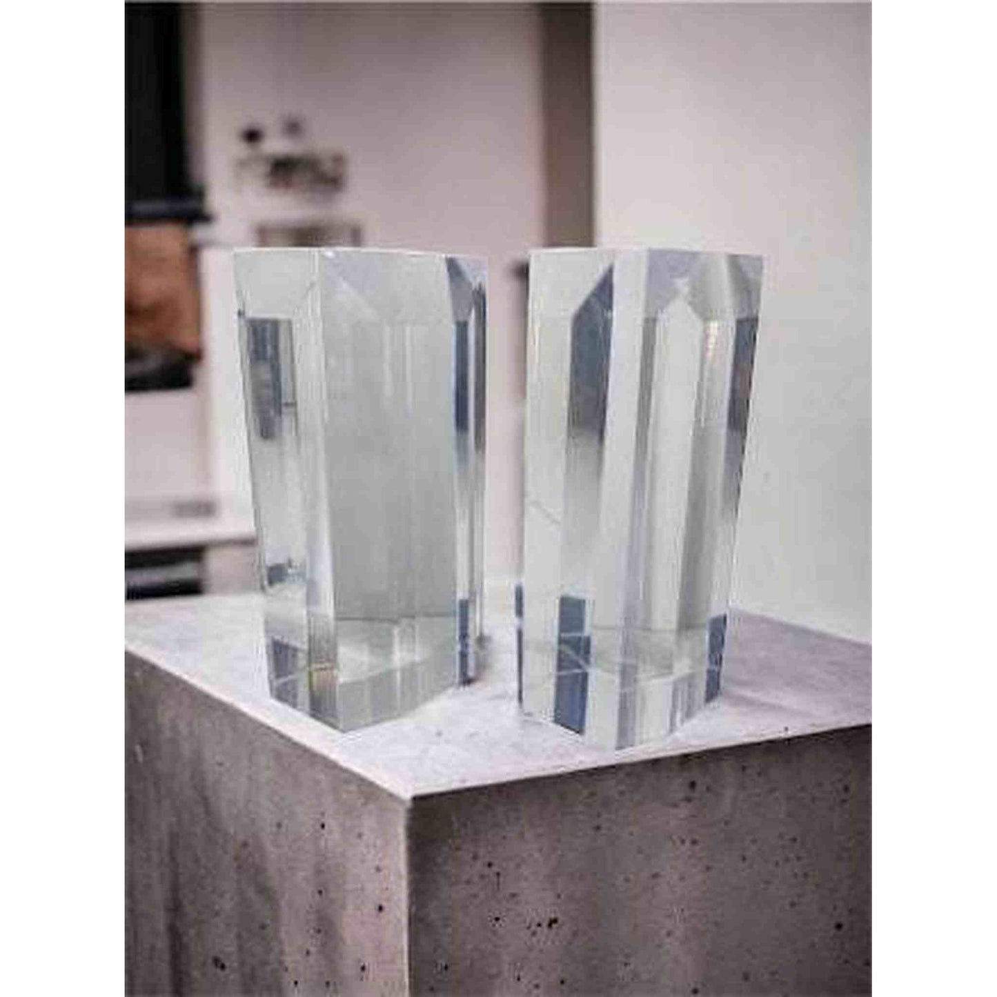 
                  
                    Astrolite beveled lucite bookends clear faceted thick rectangular pair on concrete surface
                  
                