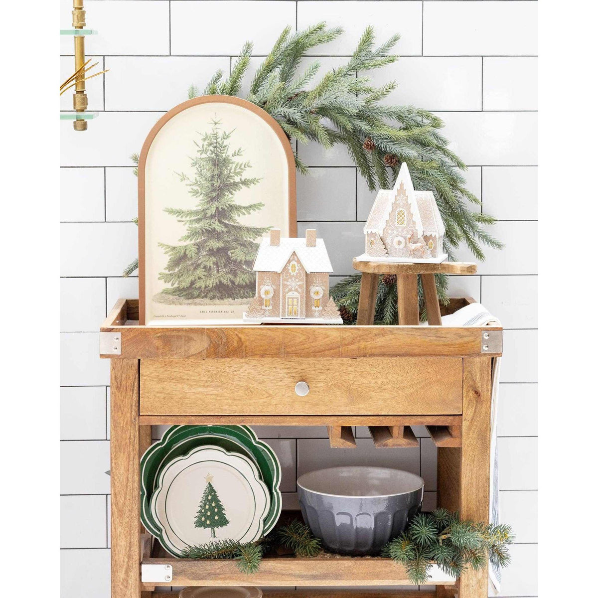 
                  
                    Gingerbread House Christmas decoration with battery light and glitter accents on wooden table with holiday decor
                  
                