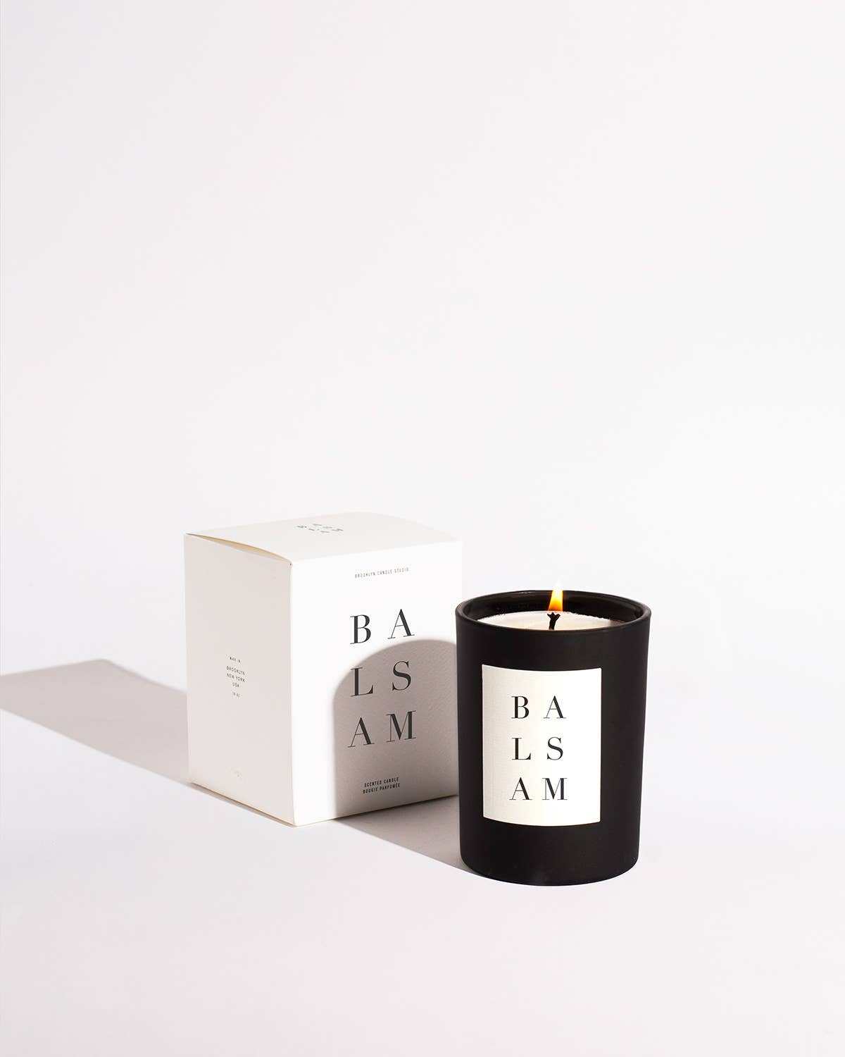 Balsam Noir Candle in black matte vessel with embossed white label and packaging, 10 oz, up to 70-hour burn time
